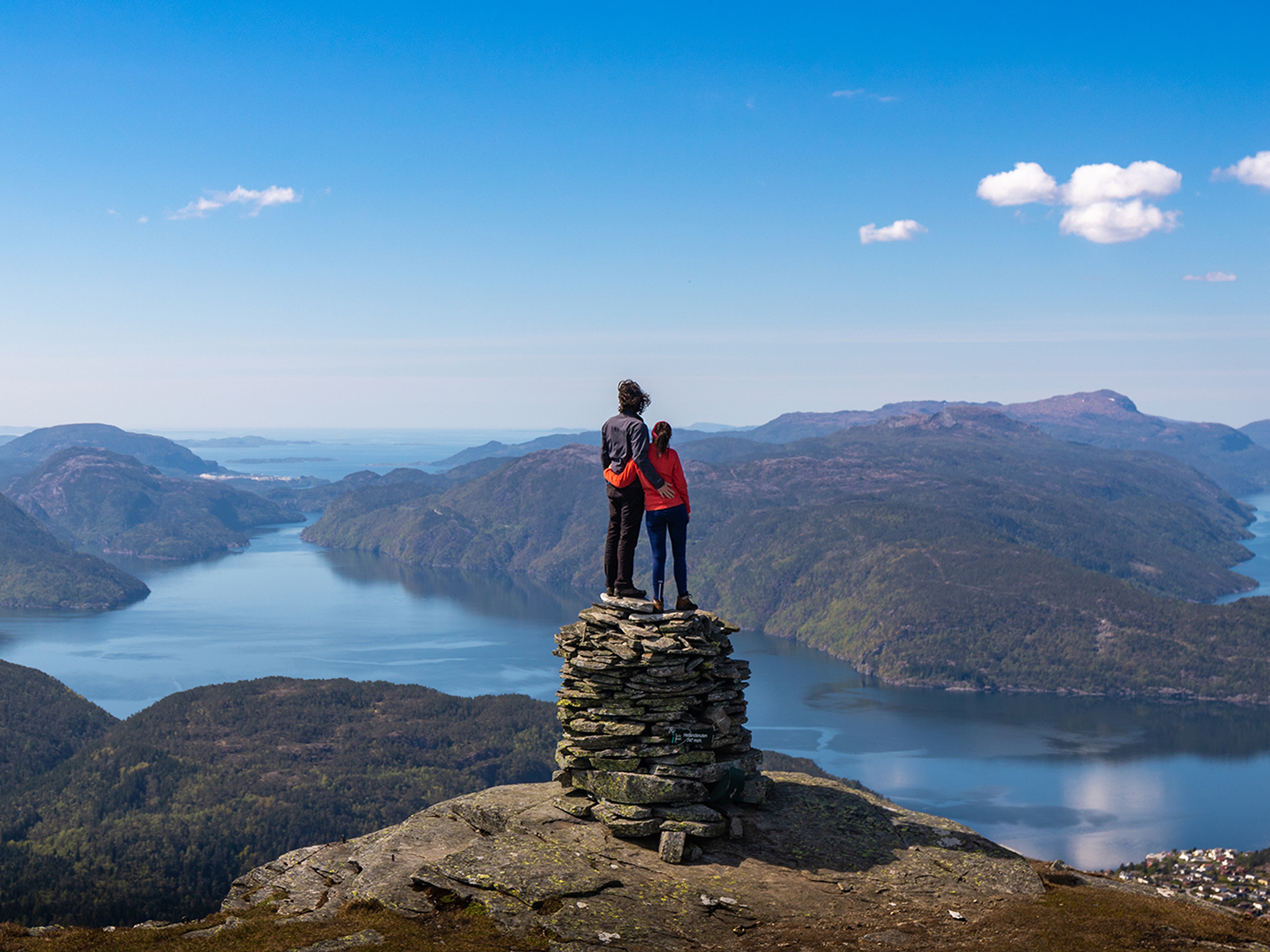 A couple on a mountain top with fjord view in Suldal in Ryfylke, Fjord Norway