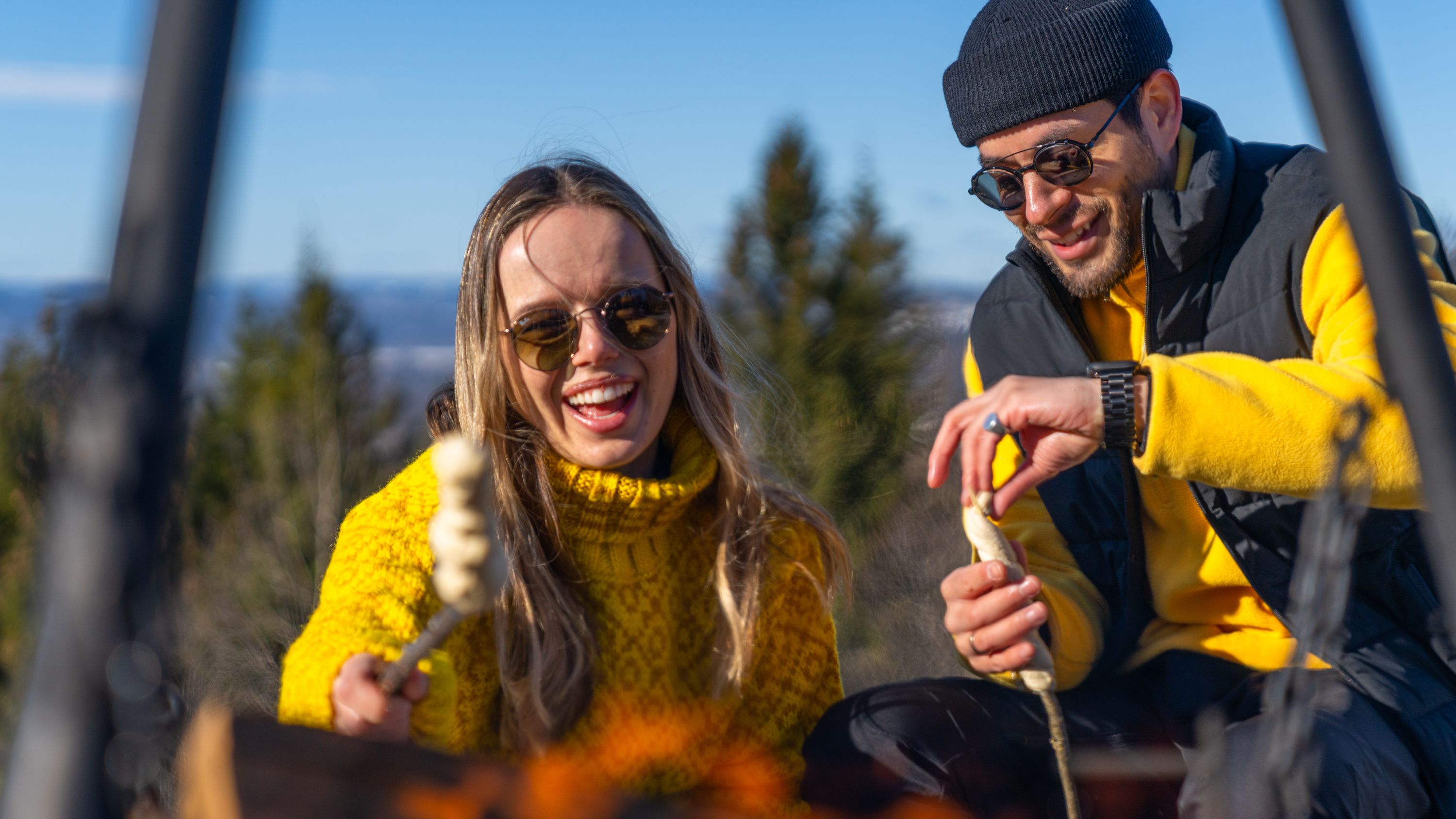 Friends making pinnebrød at the campfire in the woods, Grefsenkollen, Norway