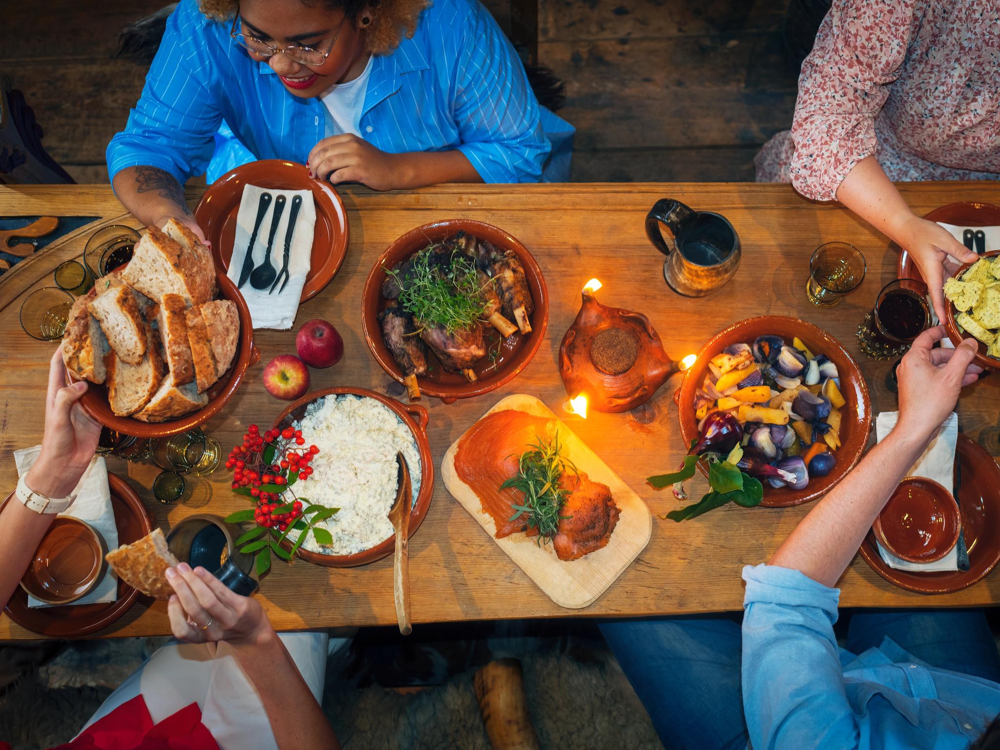 People enjoying local foods at Stiklestad