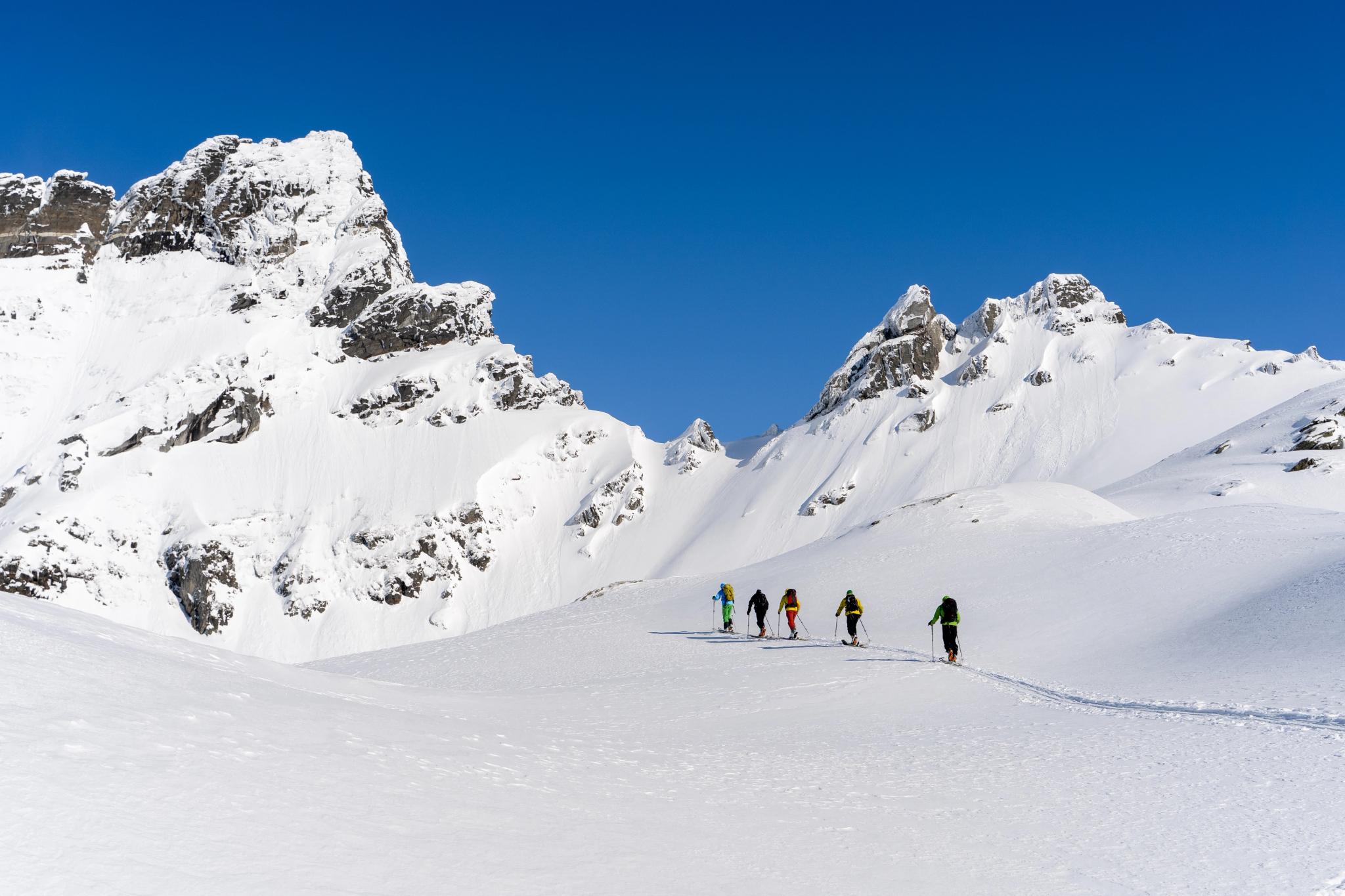 A group of people ski touring in the mountains