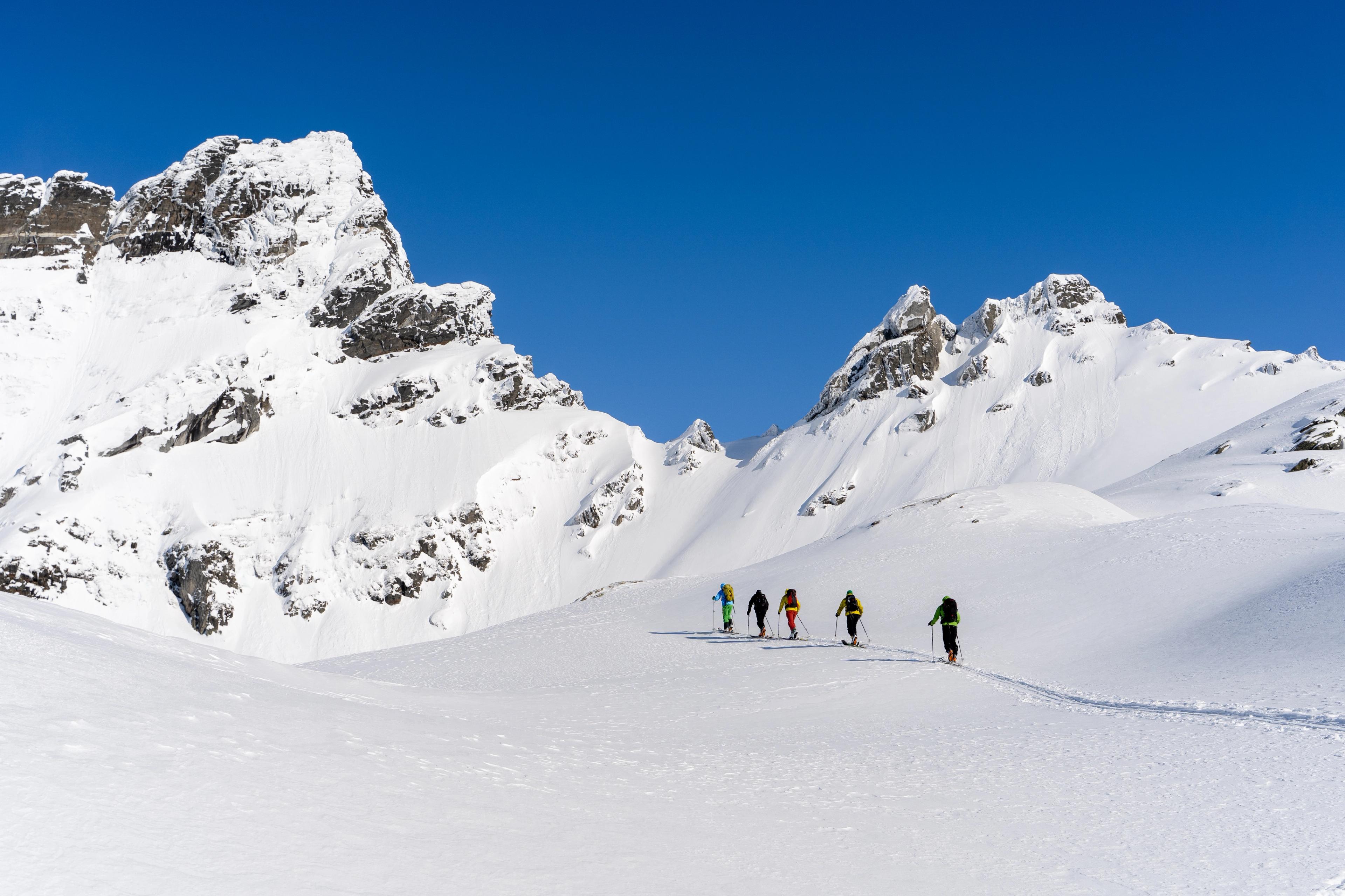 A group of people ski touring in the mountains