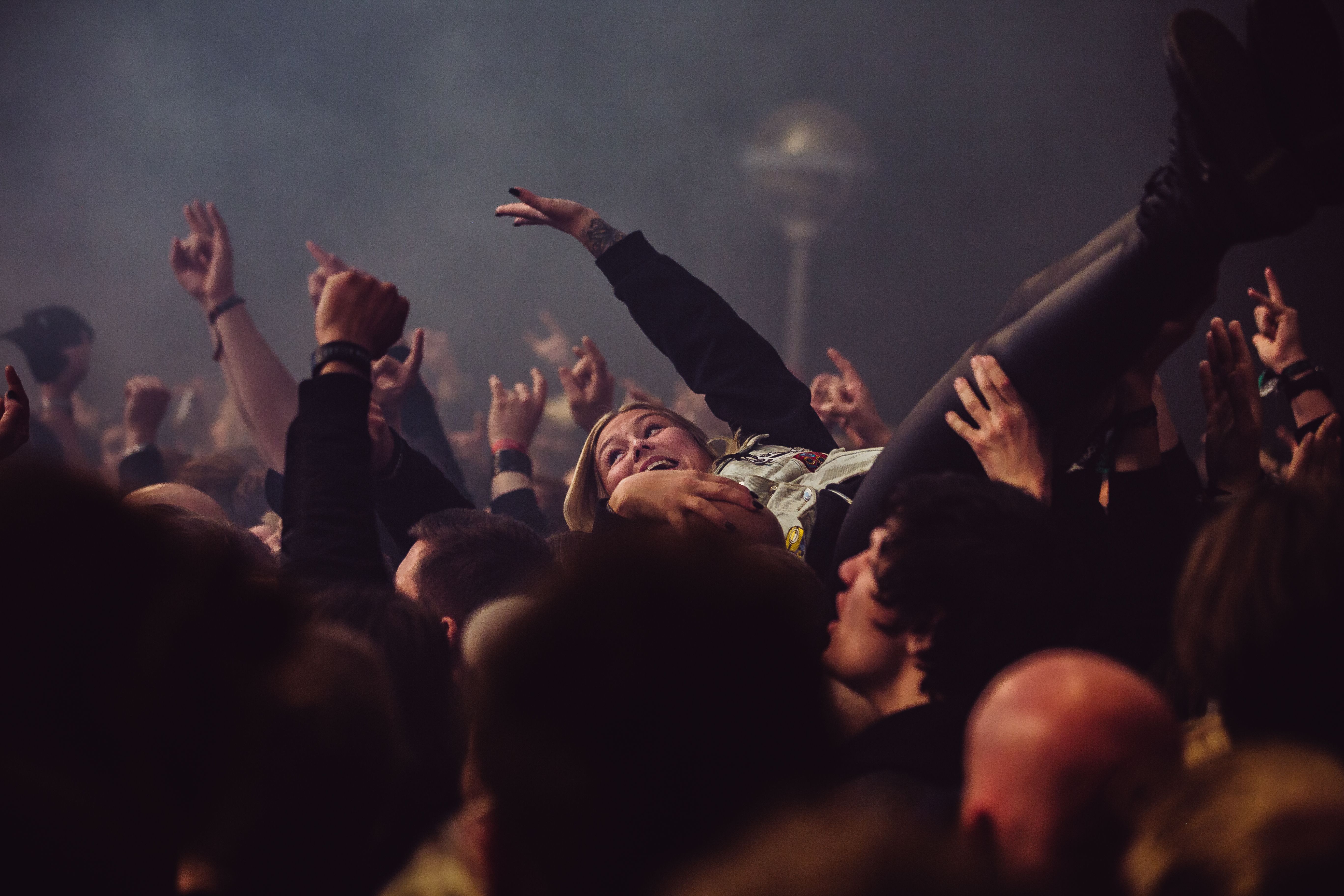 A woman is crowd surfing at Karmøygeddon Metal Festival in Haugesund in Fjord Norway