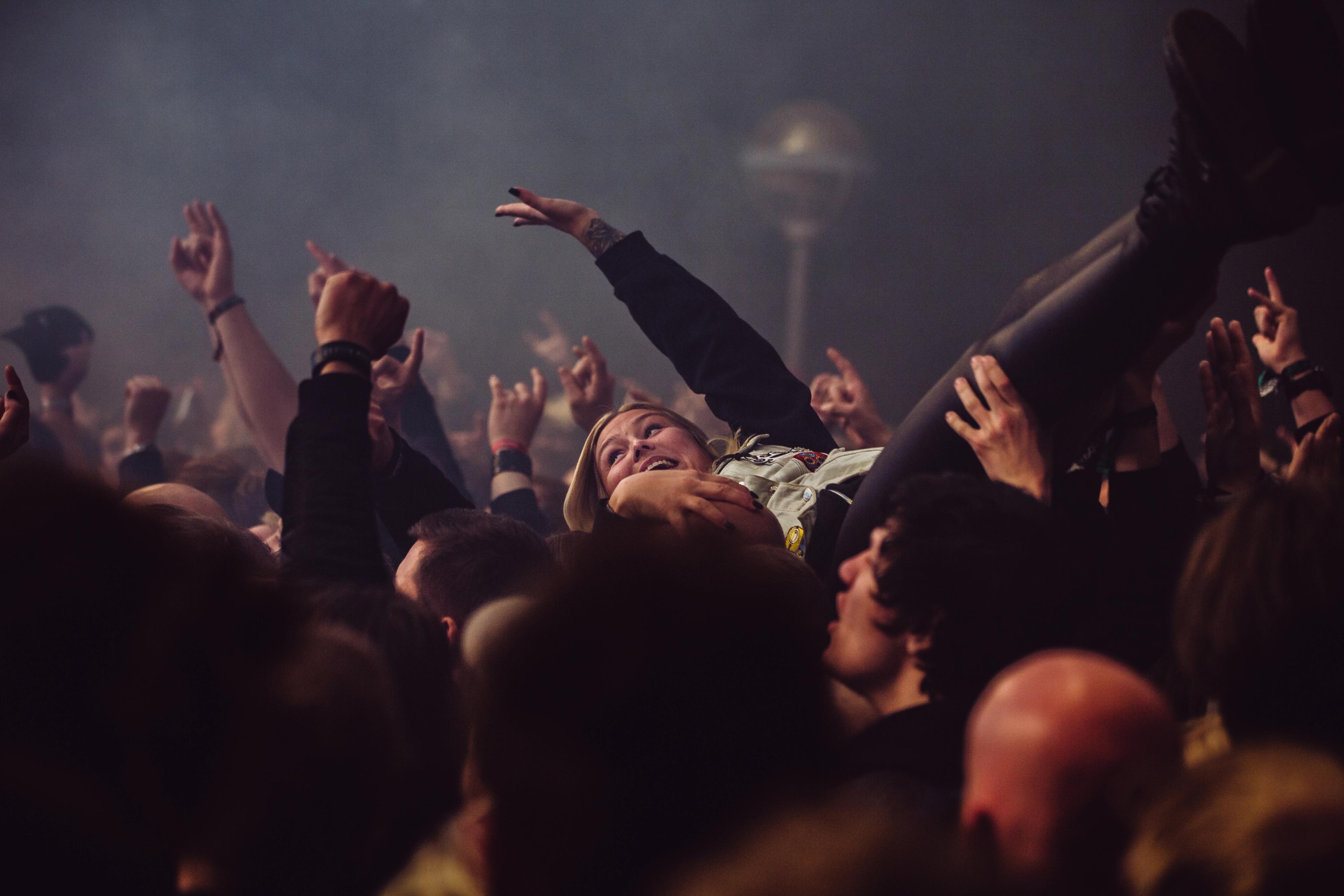 A woman is crowd surfing at Karmøygeddon Metal Festival in Haugesund in Fjord Norway