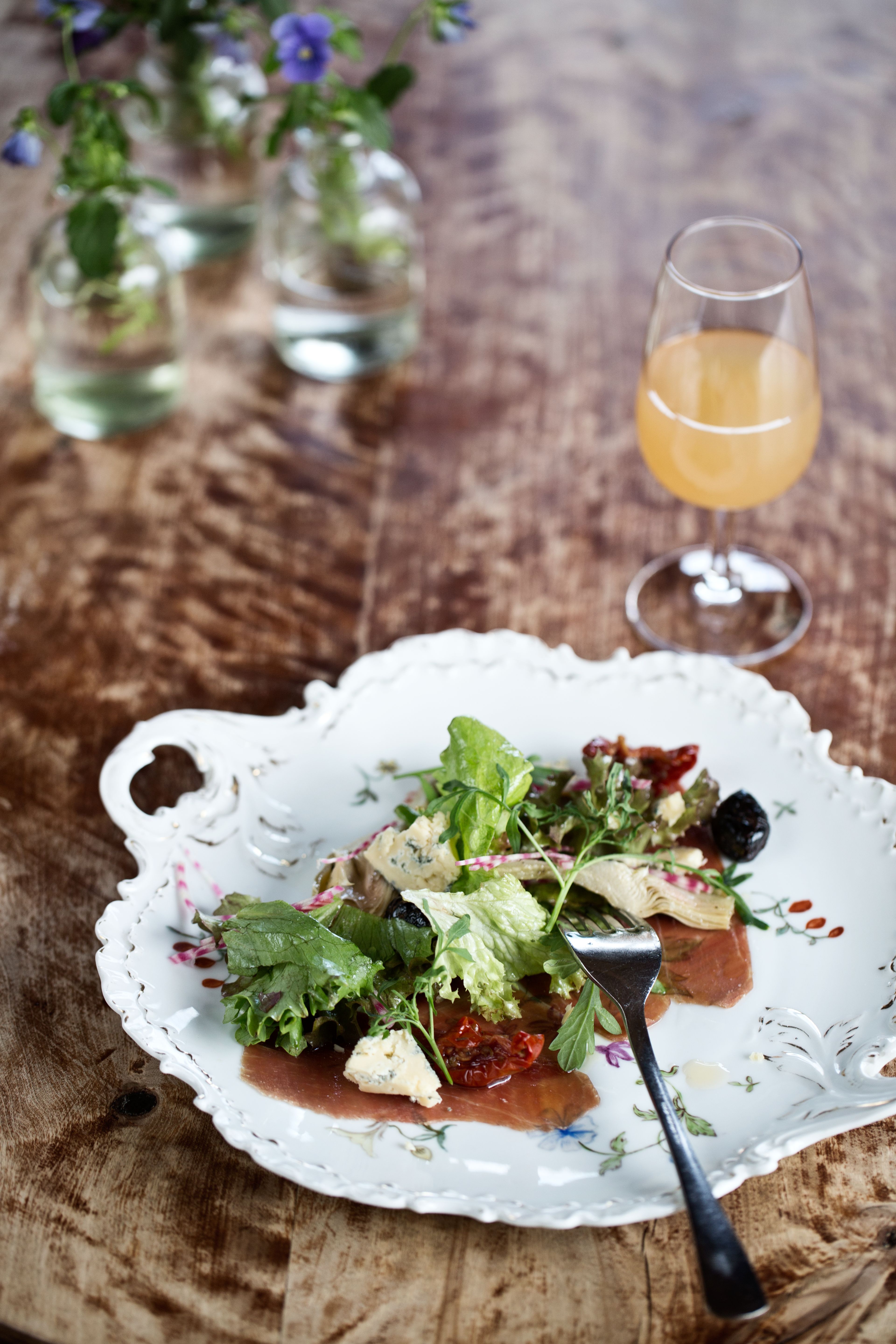 A salad at a plate on a wooden table