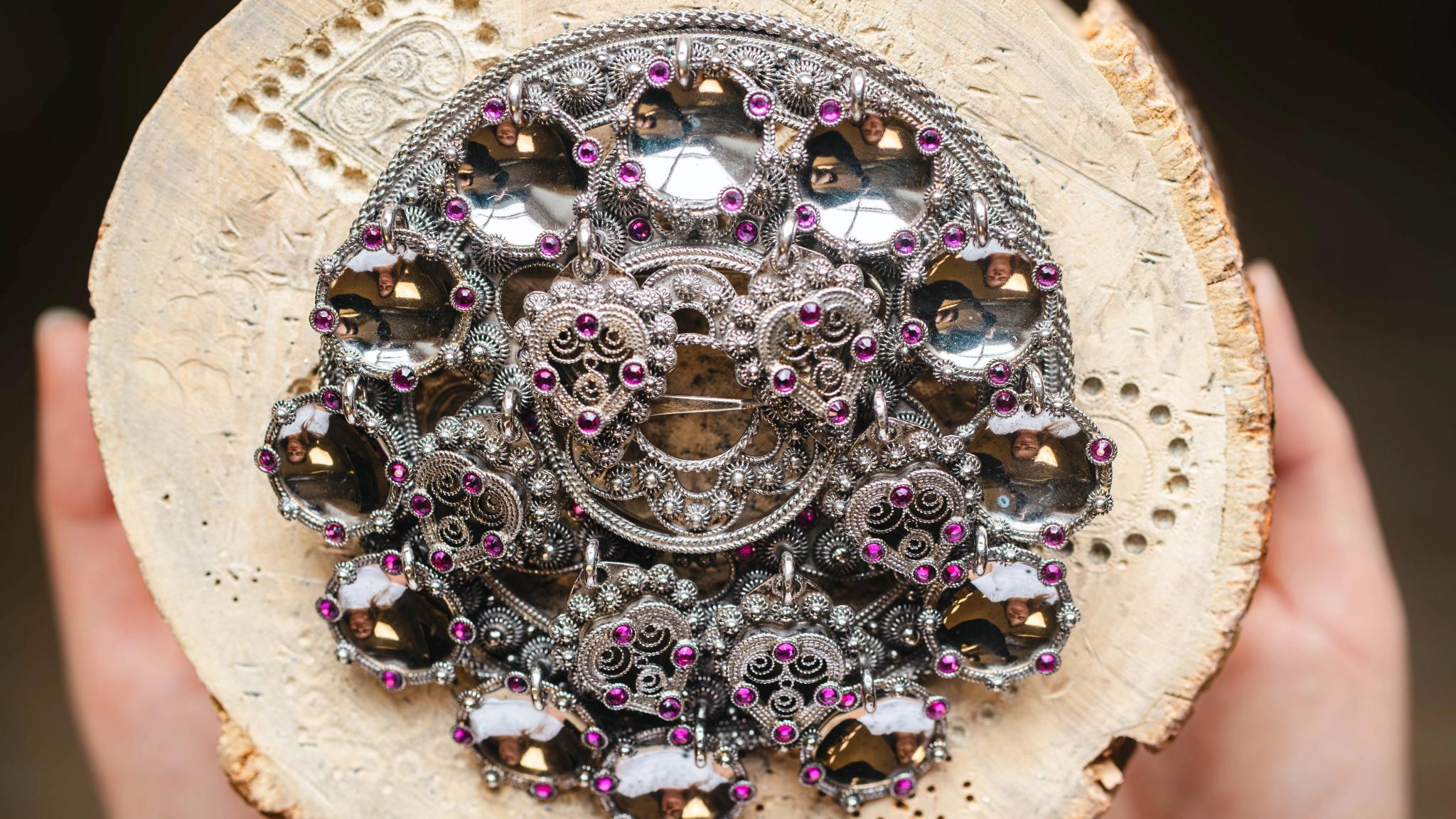 Bolesølje, atraditional Norwegian bunad brooch with raised rings attached in a circle on a base plate.