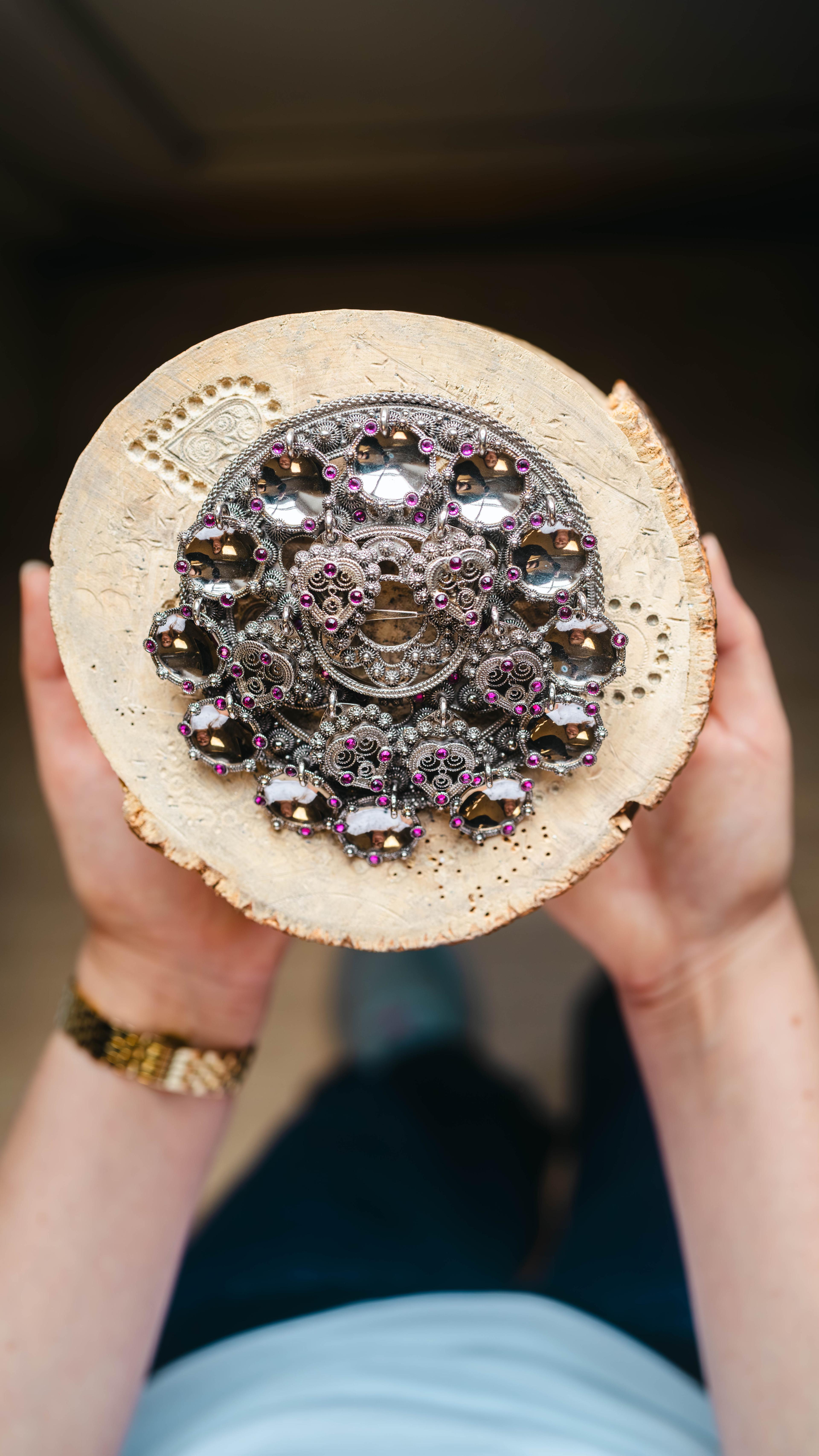 Bolesølje, atraditional Norwegian bunad brooch with raised rings attached in a circle on a base plate.