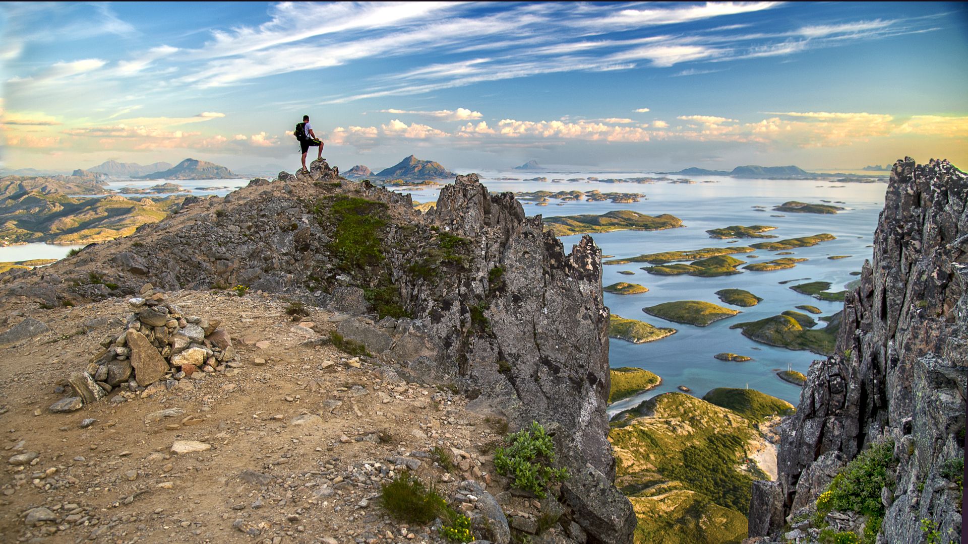 Man on top of the mountain Rødøyløva above the polar circle