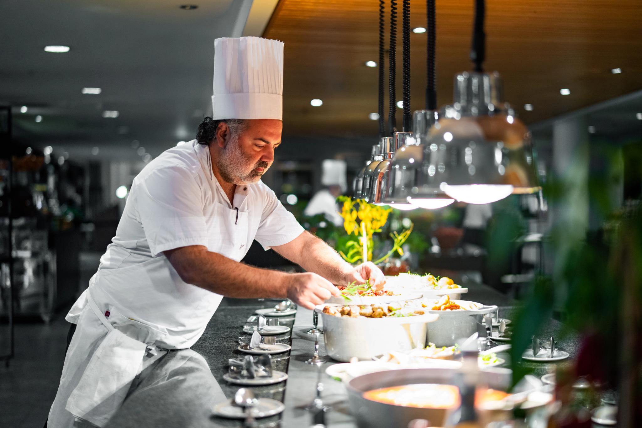 A chef preparing breakfast at the kitchen.