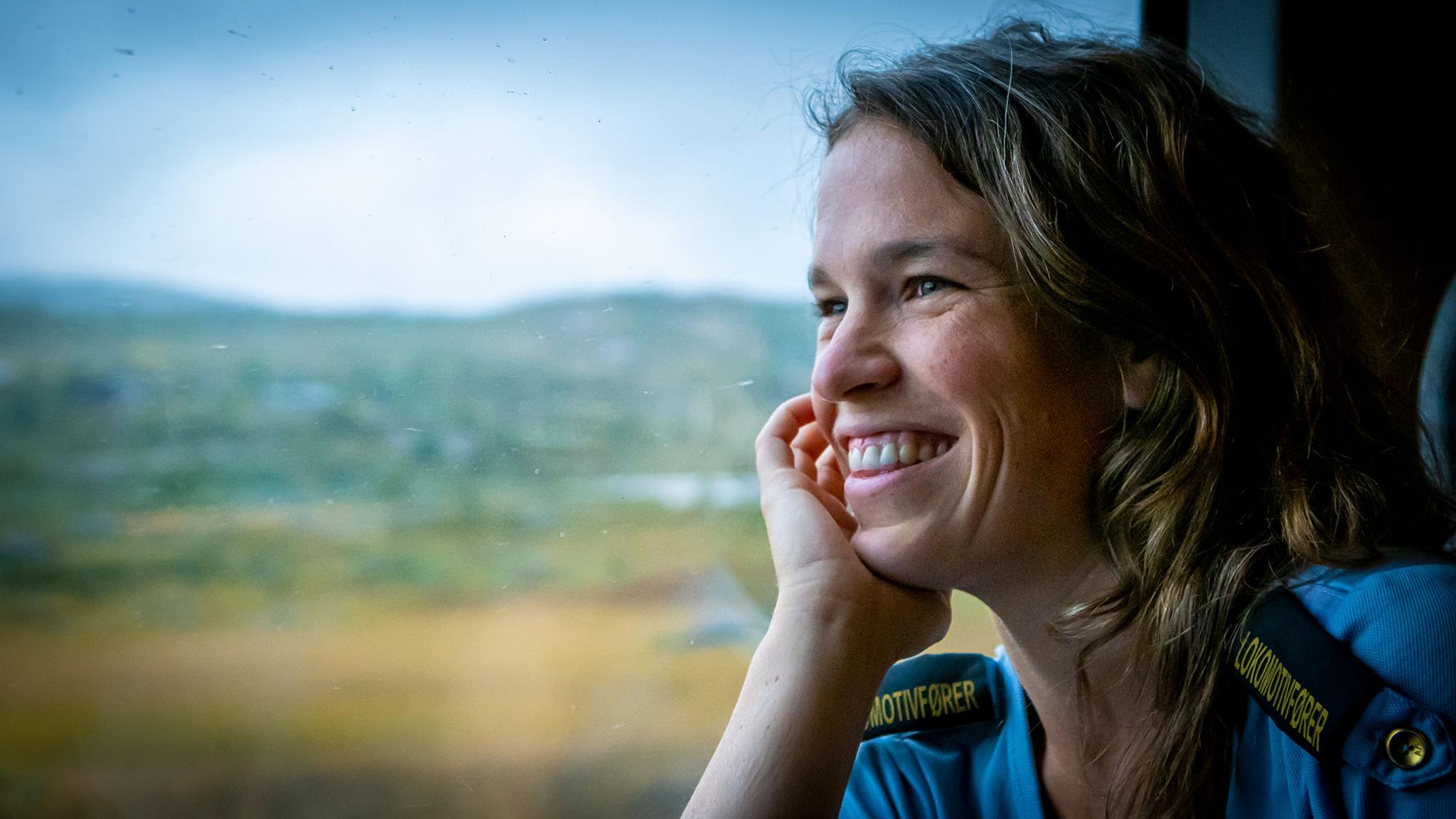 A train driver is looking through the window at the Bergen Railway train