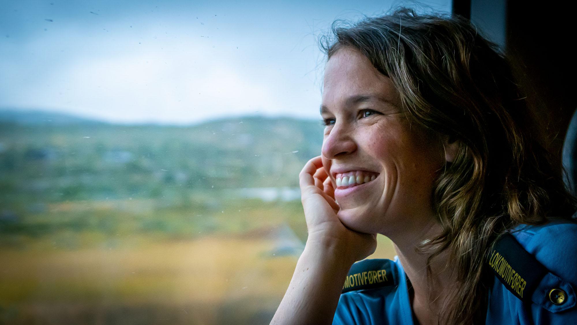 A train driver is looking through the window at the Bergen Railway train