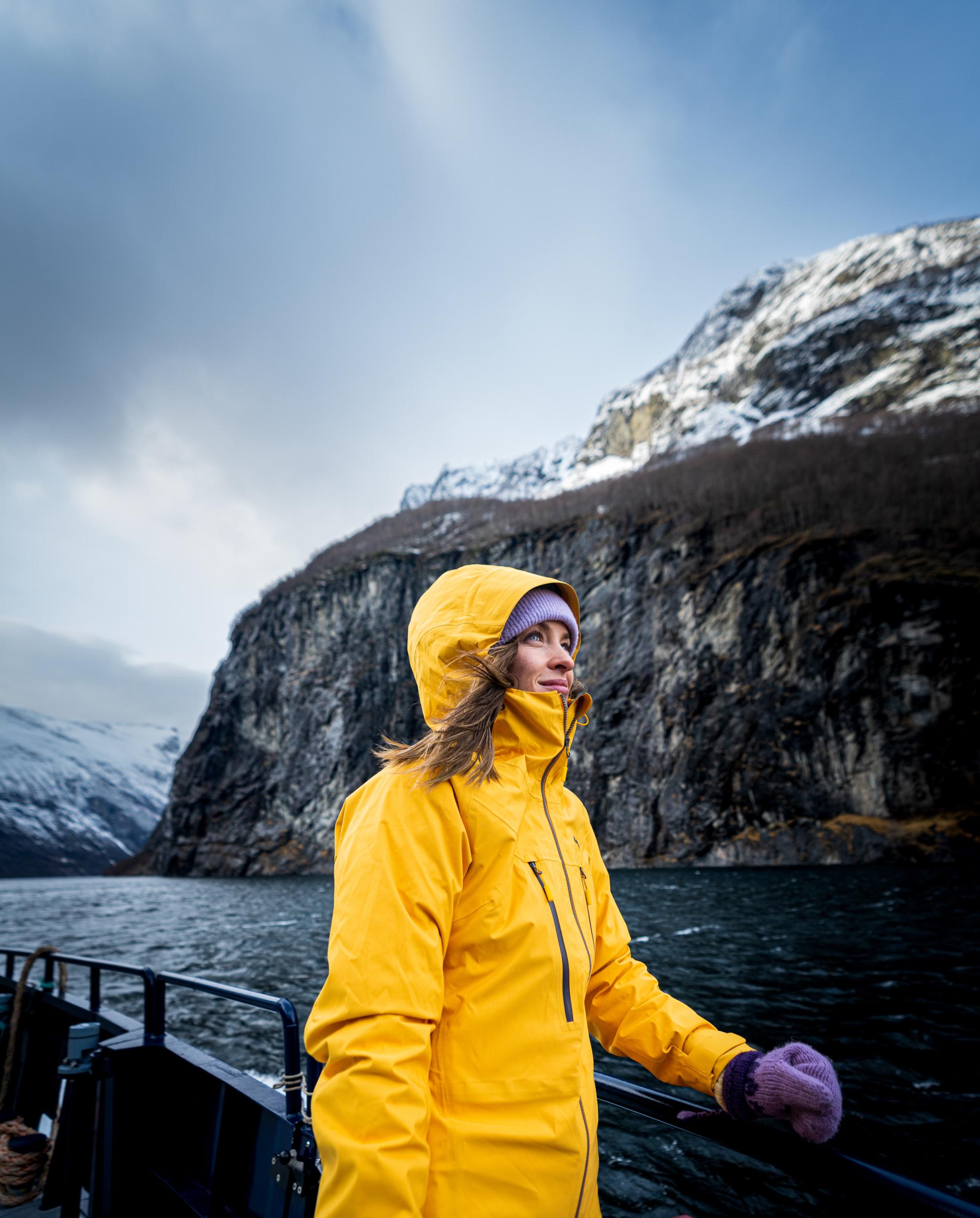 Woman enjoying the view from Geiranger fjordservice cruise boat in Geiranger