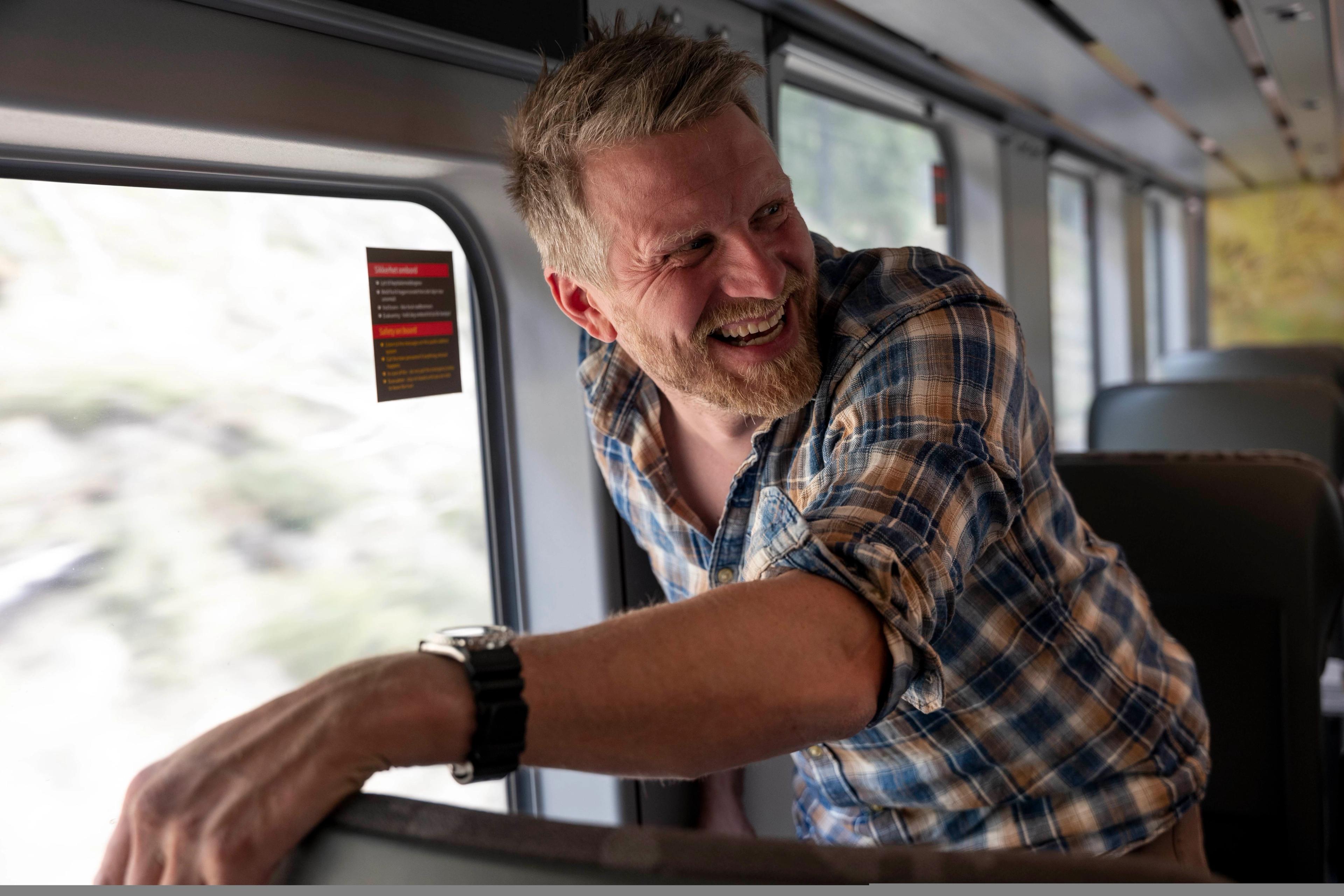 A man standing in the Nordland Railway train, Norway.