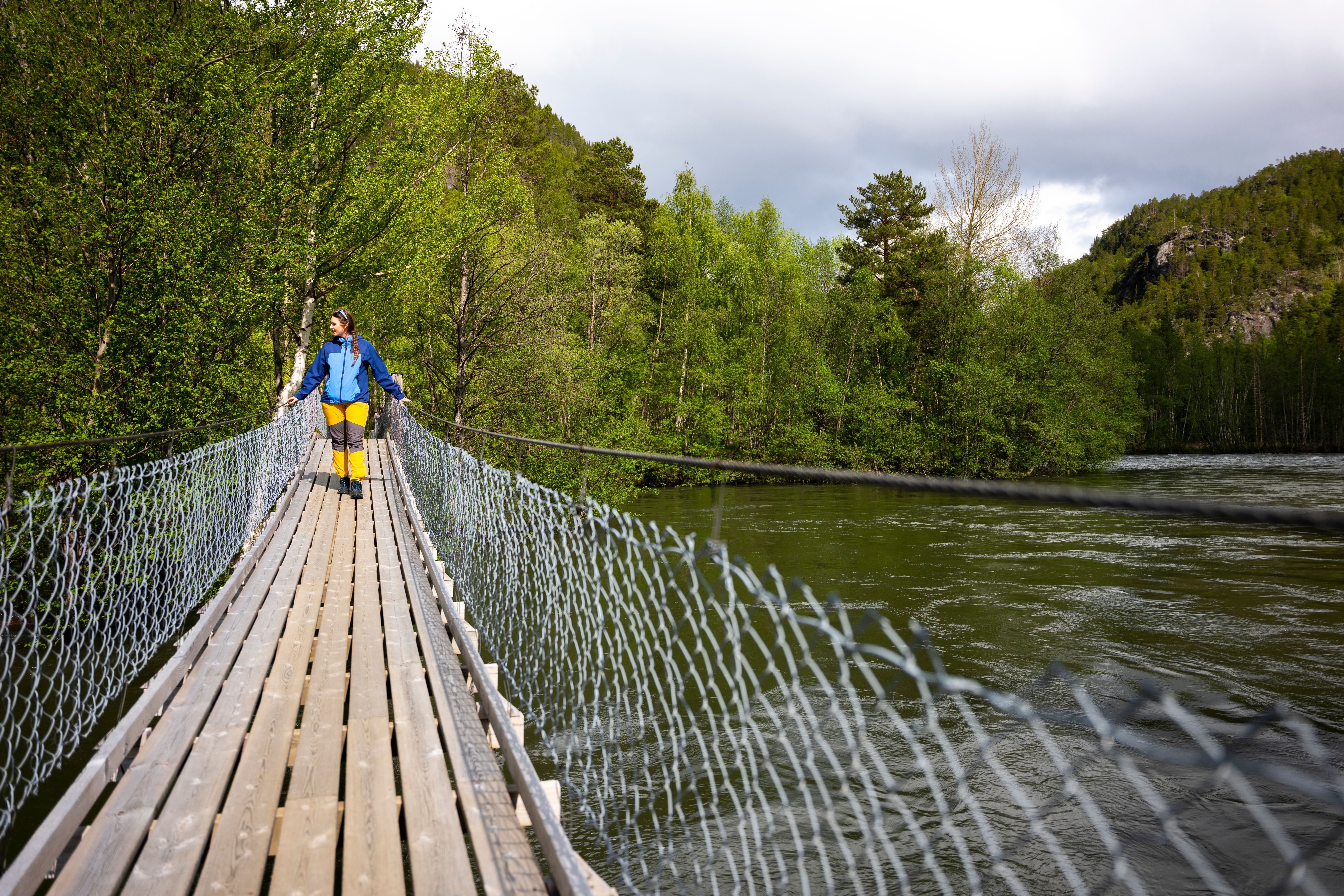 A woman walking over a hanging brigde, Salten.