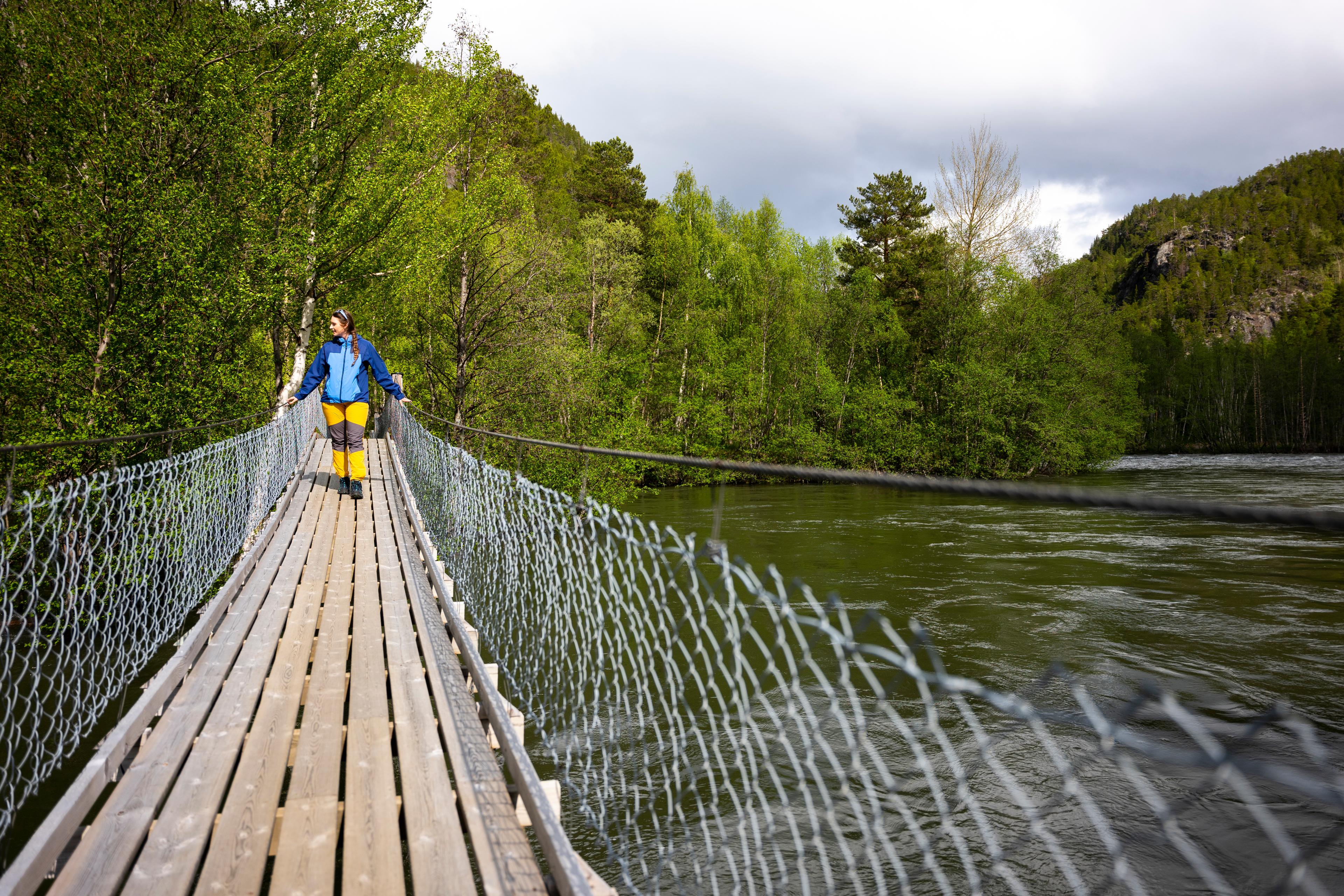 A woman walking over a hanging brigde, Salten.