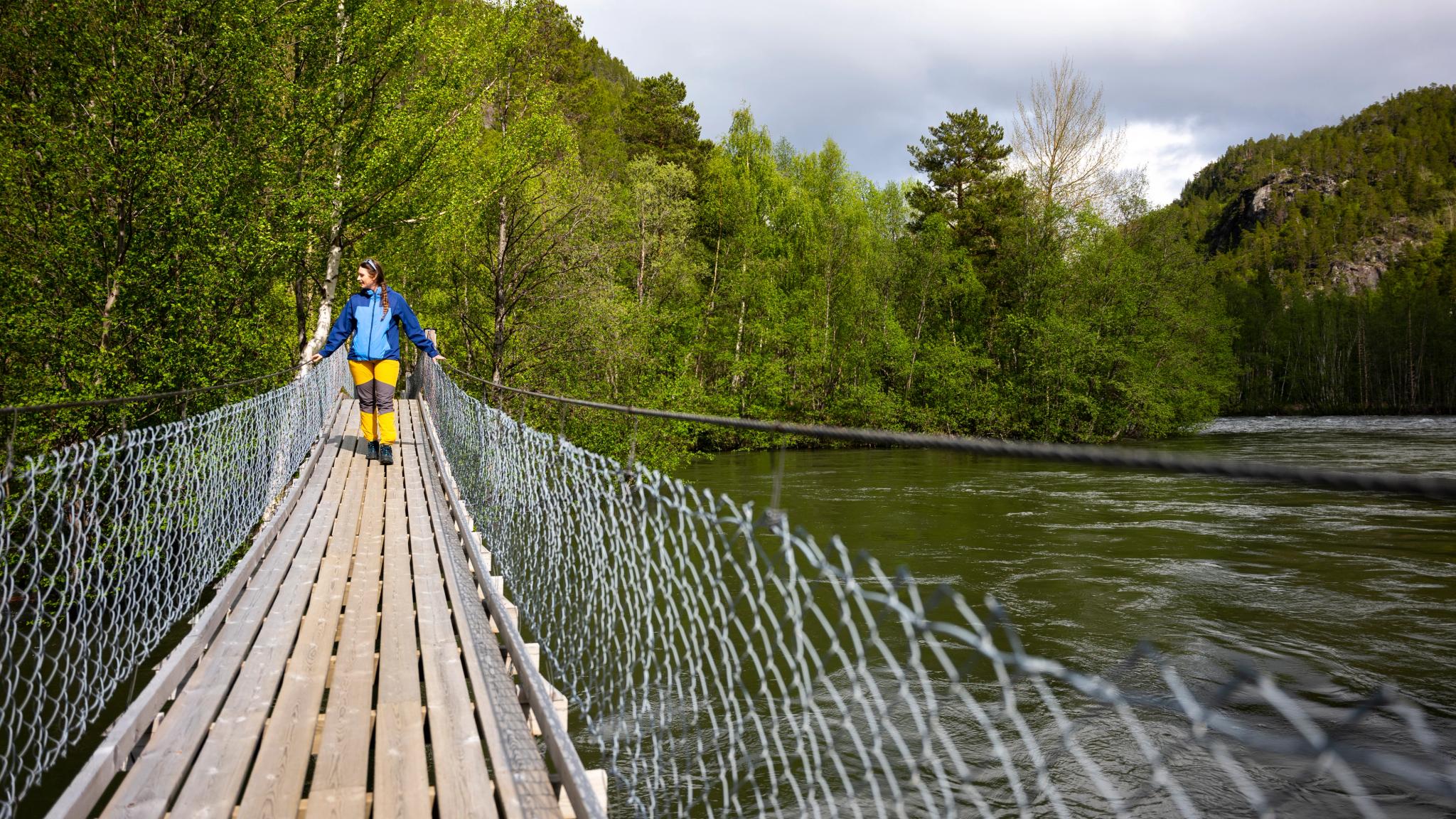 A woman walking over a hanging brigde, Salten.
