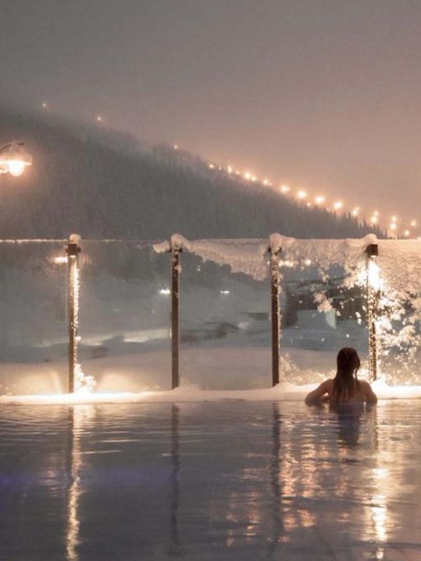 Woman enjoying view from a pool at Fyri resort, Hemsedal