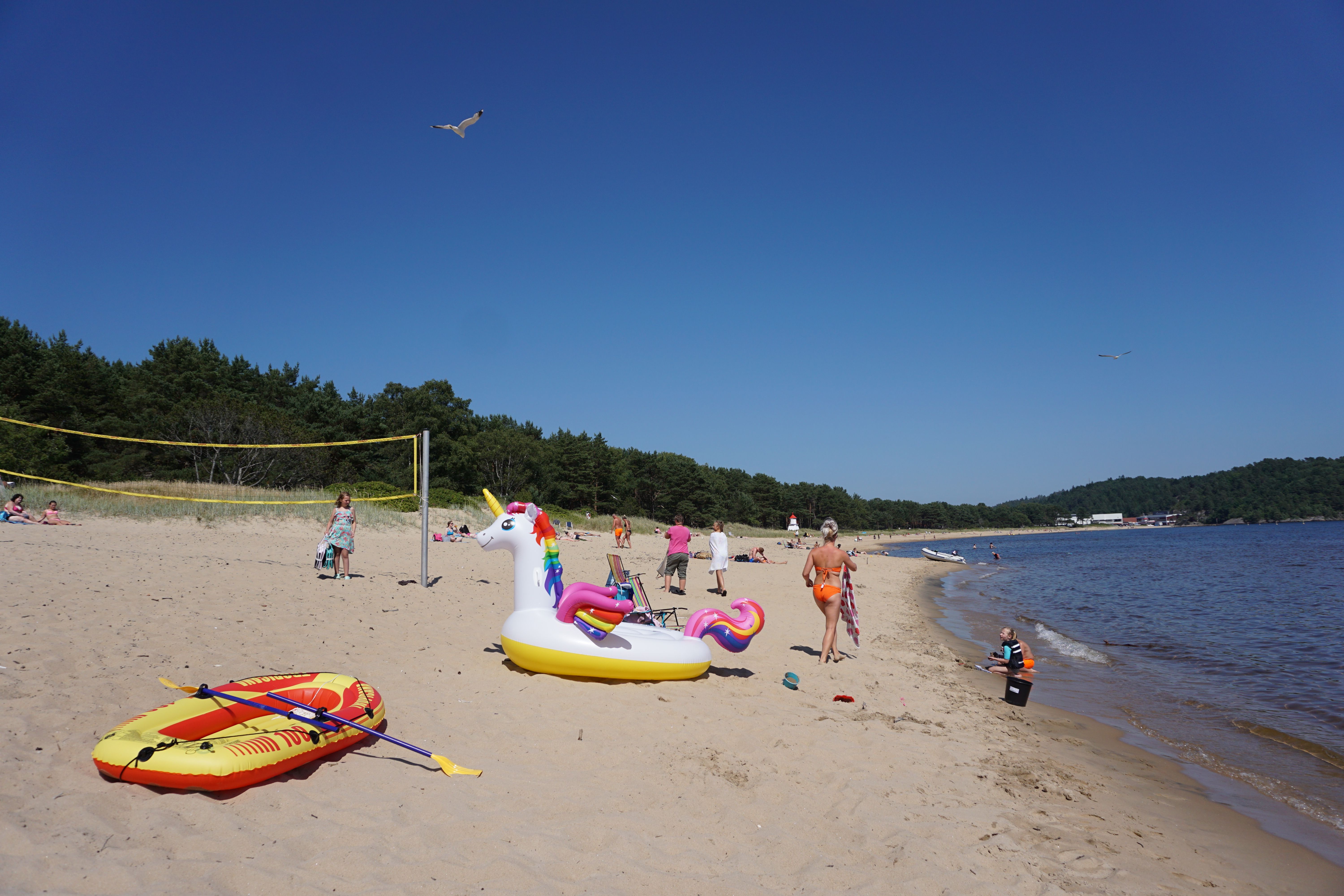 People having fun in the sun at Sjøsanden beach in Mandal in Southern Norway