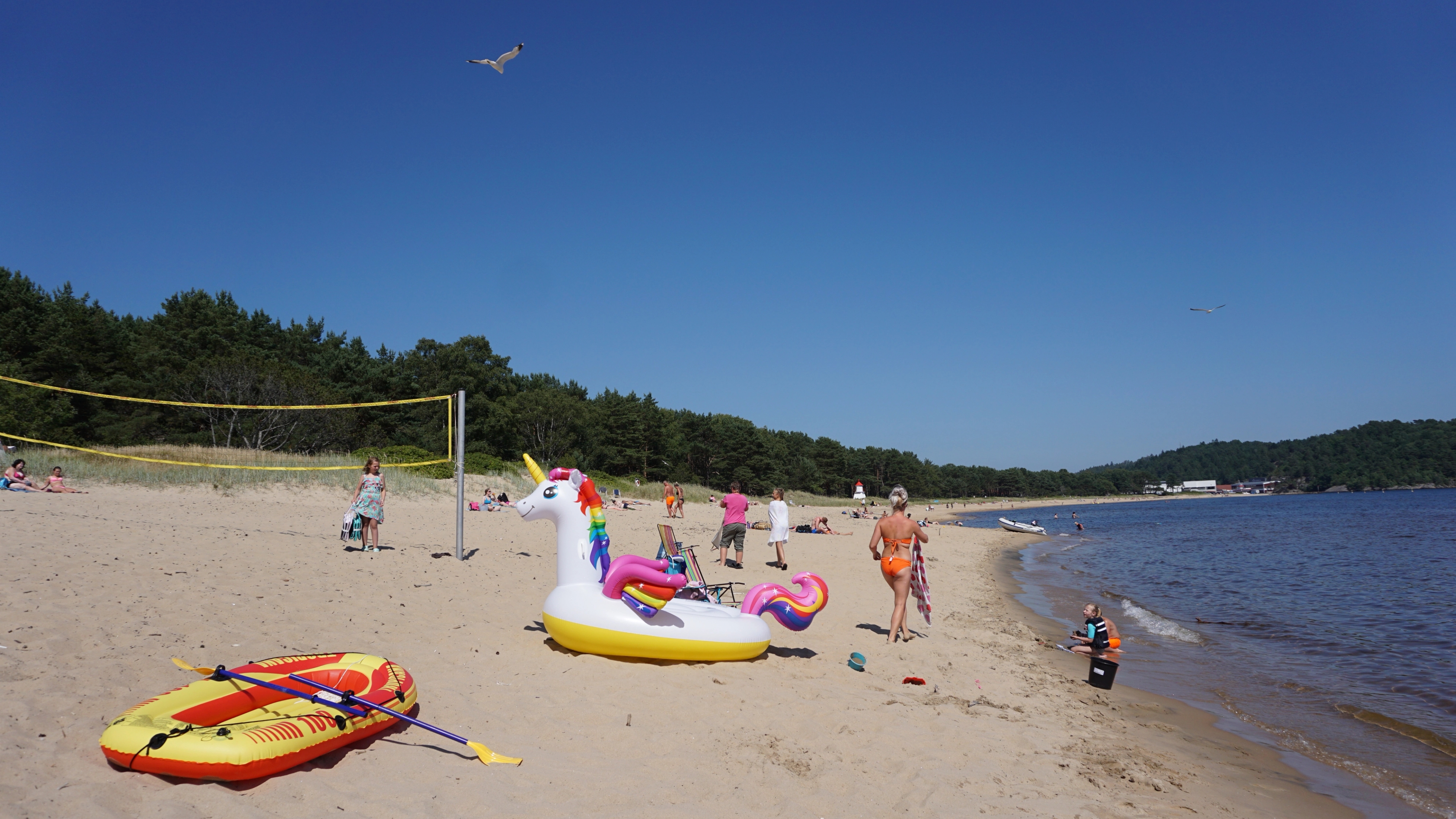 People having fun in the sun at Sjøsanden beach in Mandal in Southern Norway