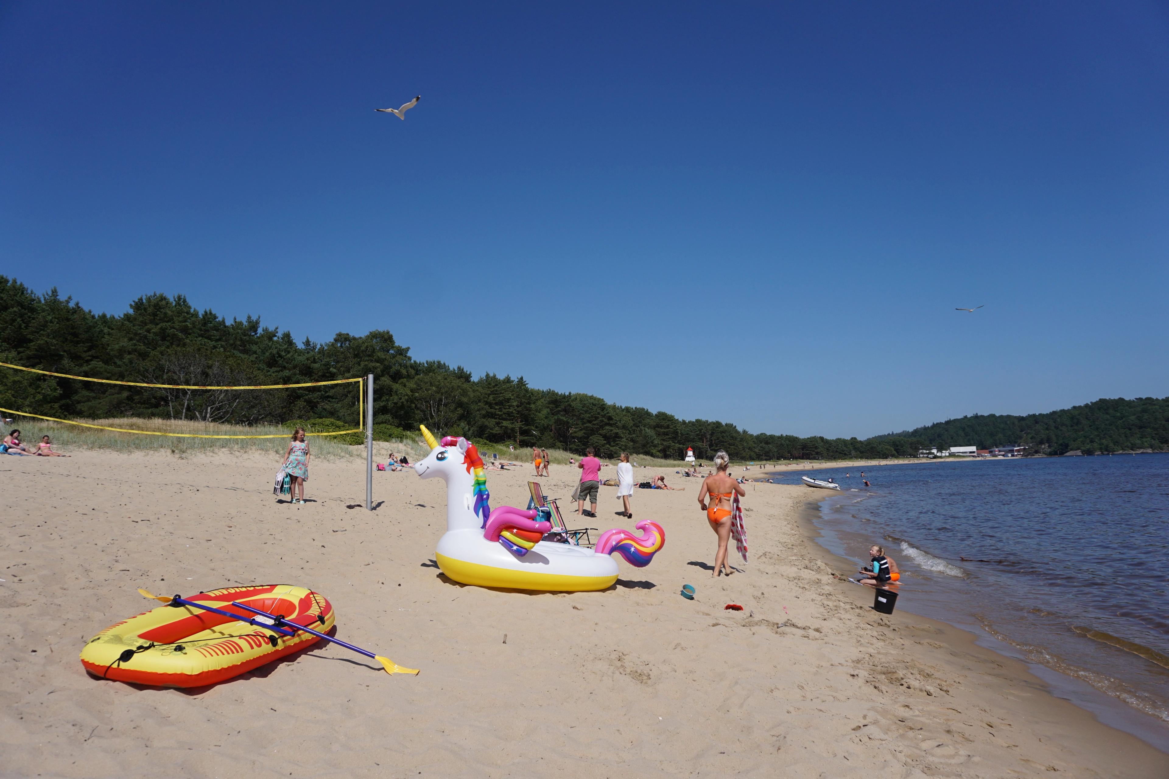 People having fun in the sun at Sjøsanden beach in Mandal in Southern Norway