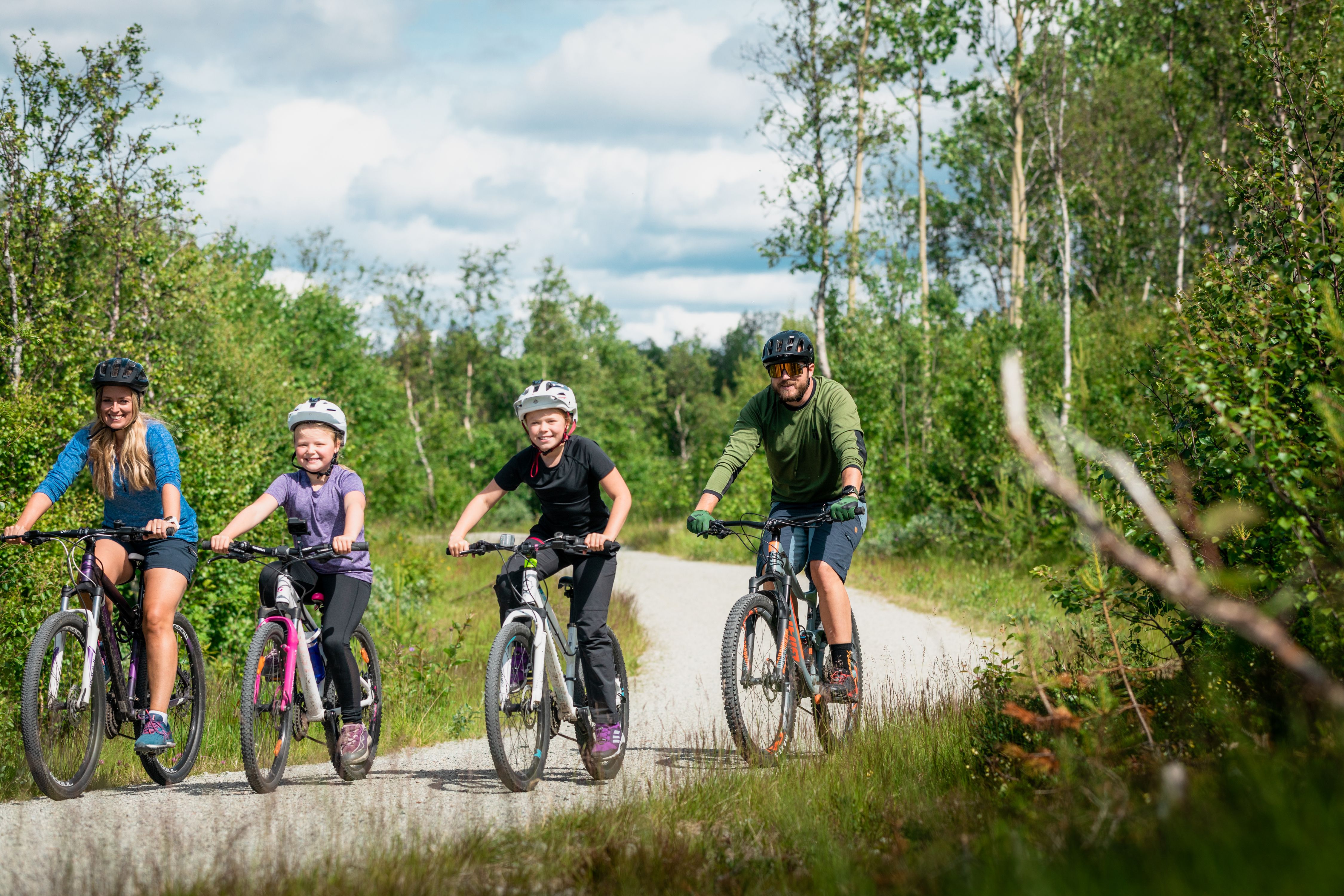 Family of four biking in a road in Geilo, Eastern Norway