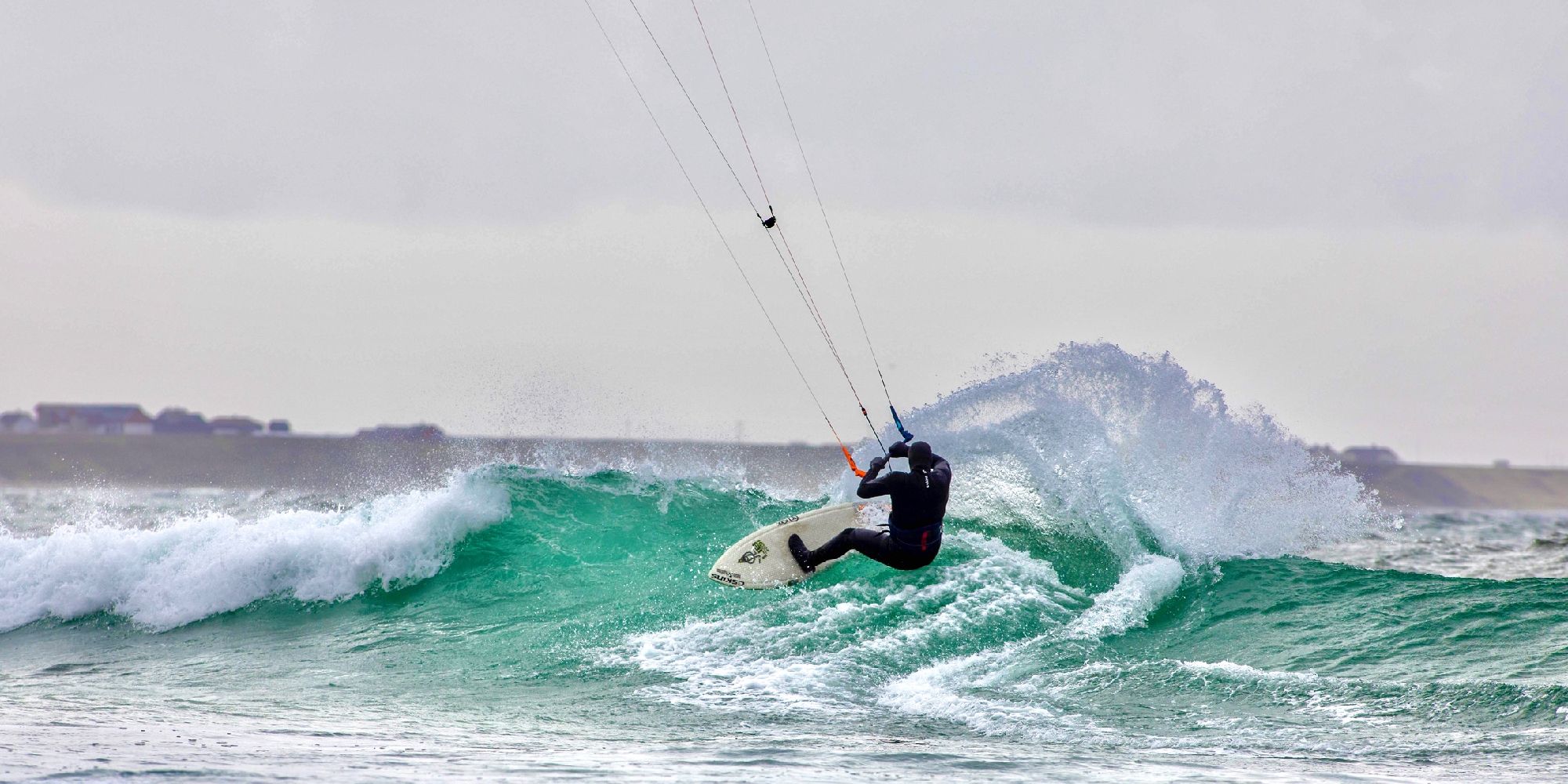 A person kiting on a wave in Fjord Norway.