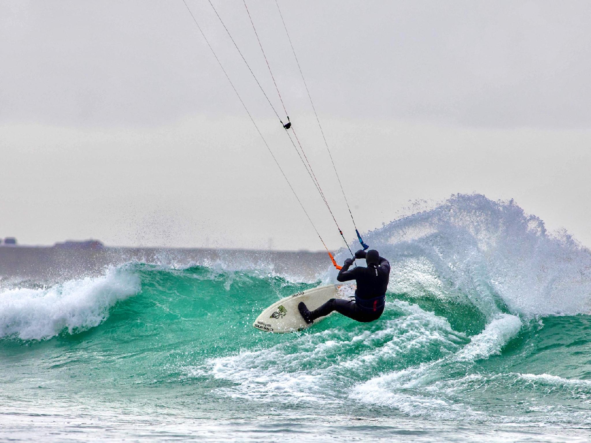 A person kiting on a wave in Fjord Norway.
