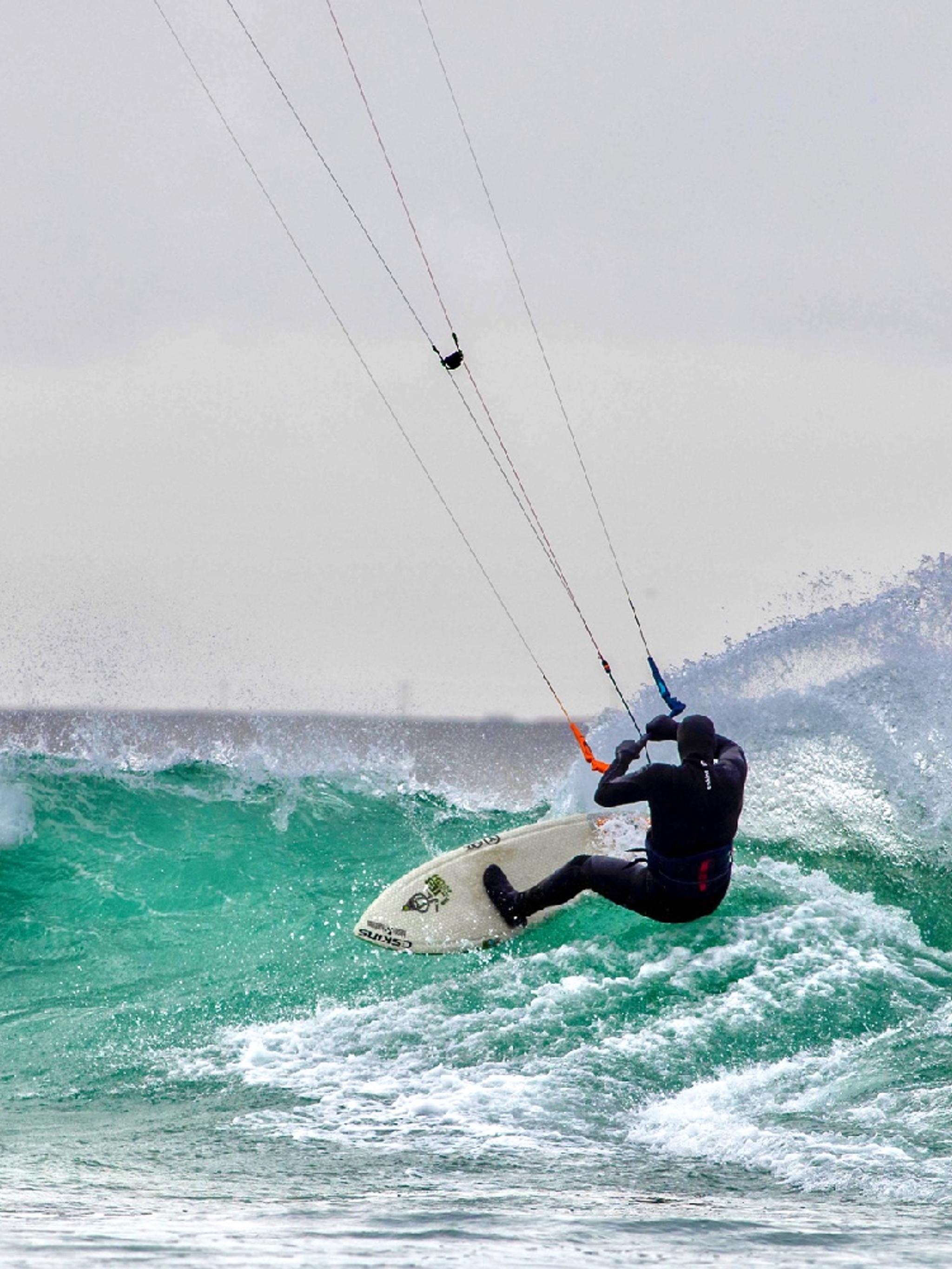 A person kiting on a wave in Fjord Norway.