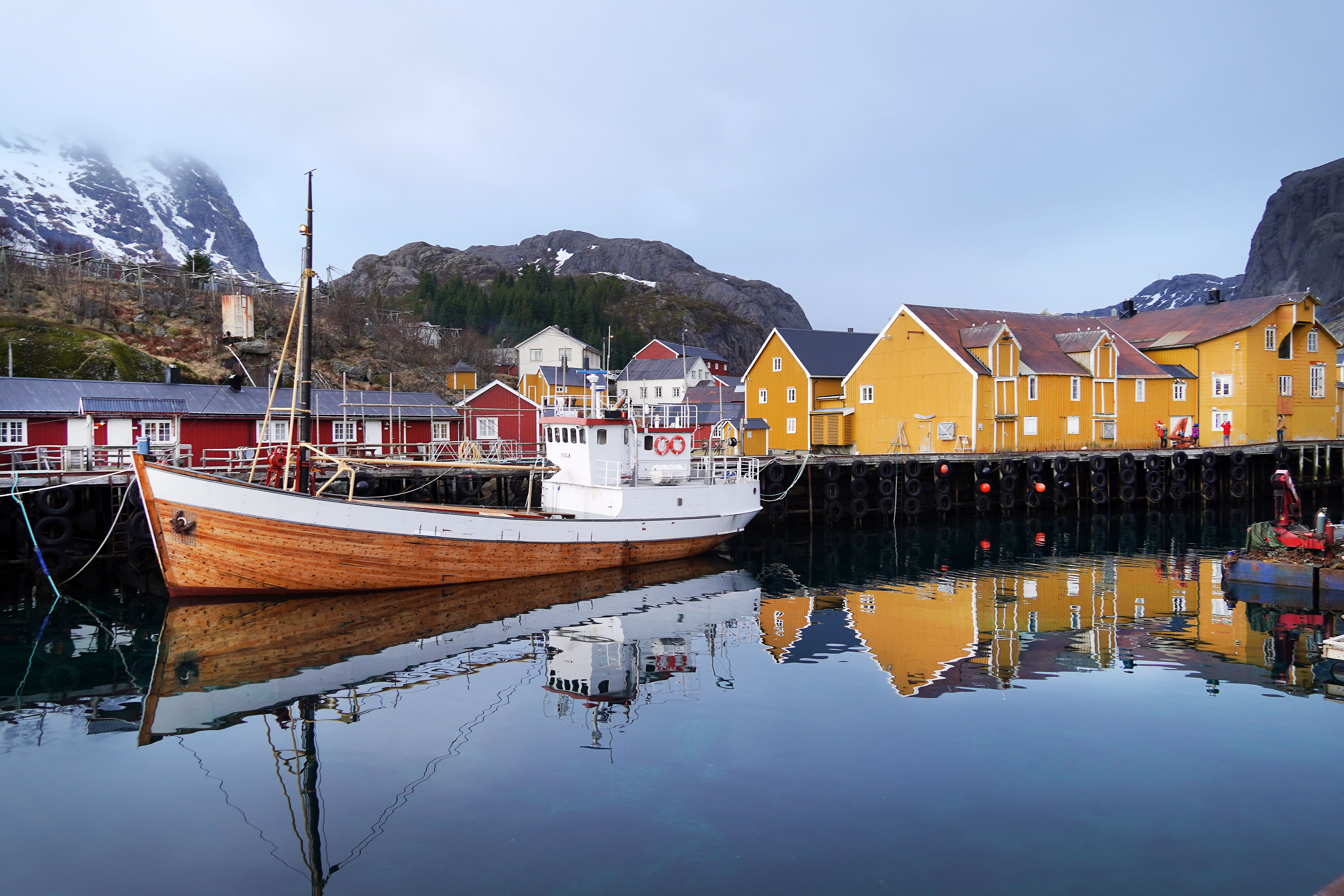 A fishing boat and fishing village with tree houses.
