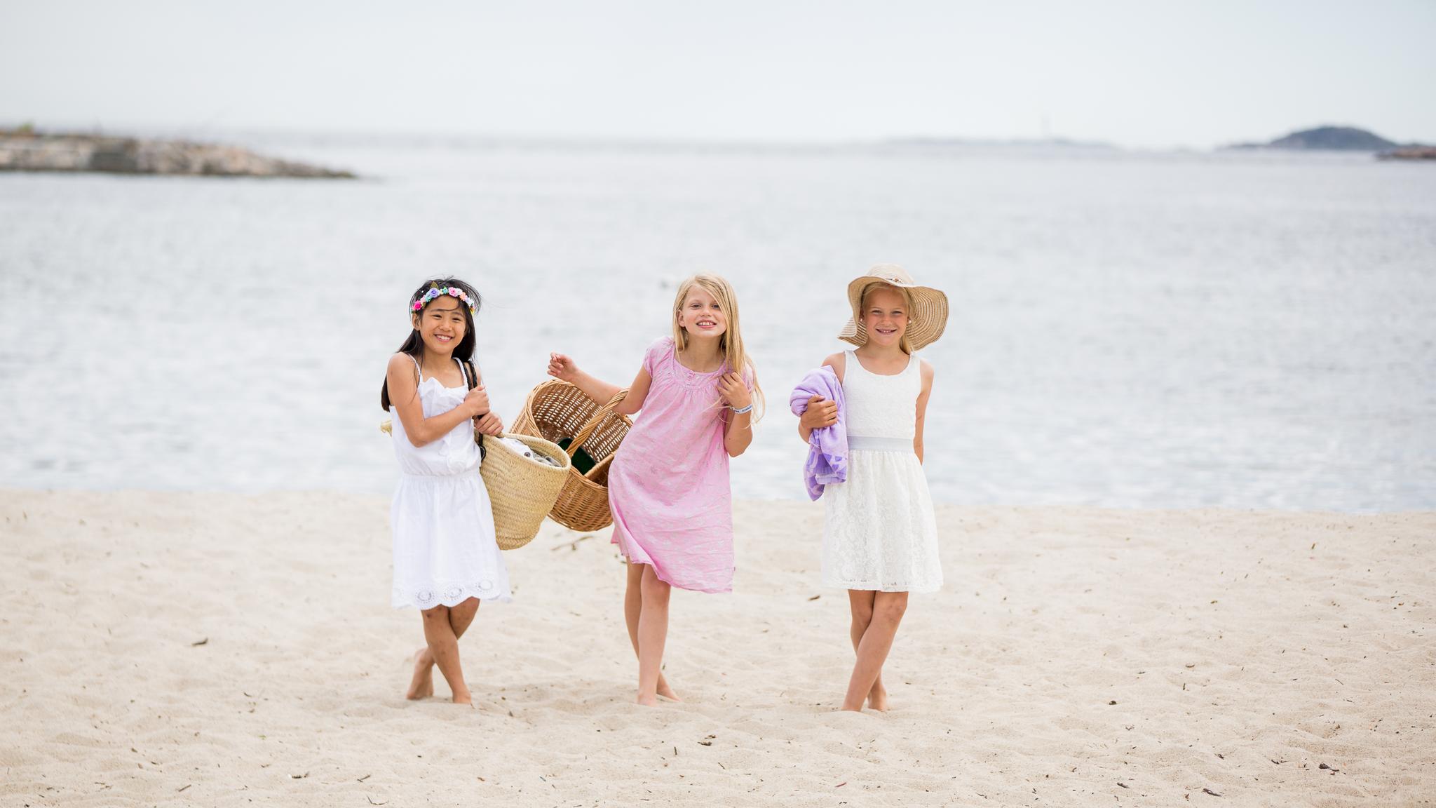 Three children on the Bystranda beach in Kristiansand, Southern Norway