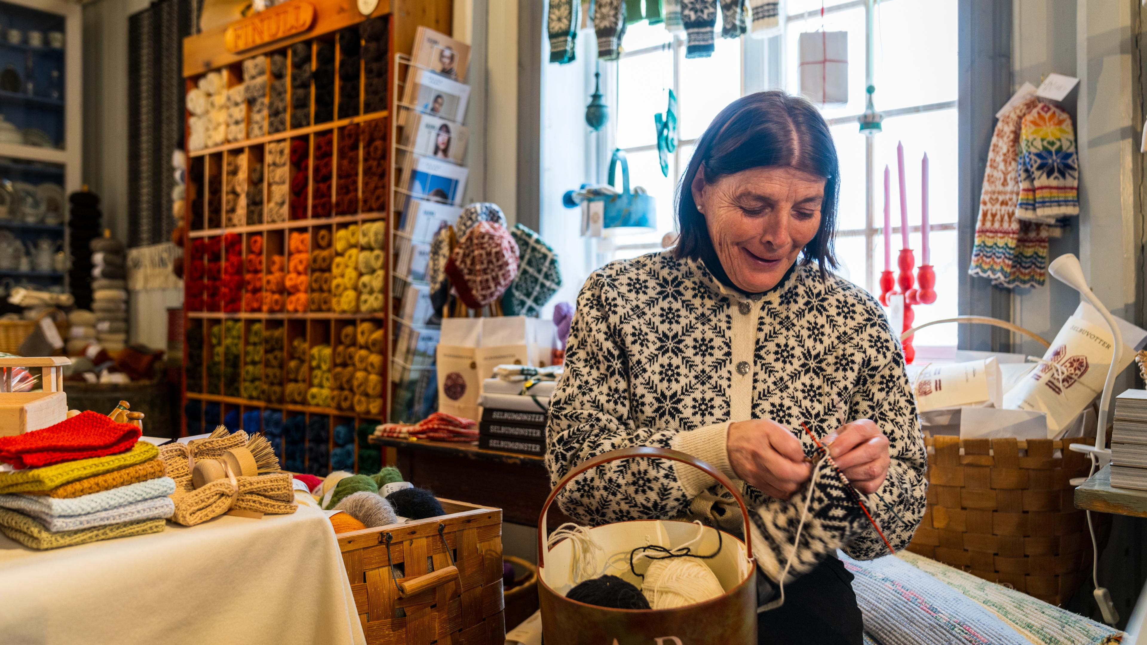 A woman knitting Selbu mittens at Selbu, Trøndelag, Norway.