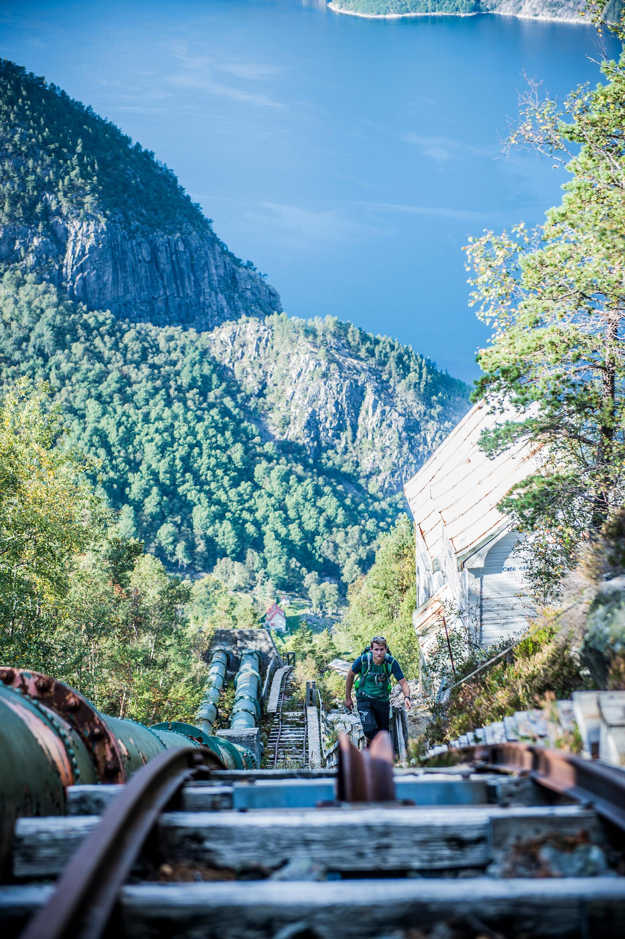 Person hiking the Flørlitrappene strais by the Lysefjord in Ryfylke, Fjord Norway