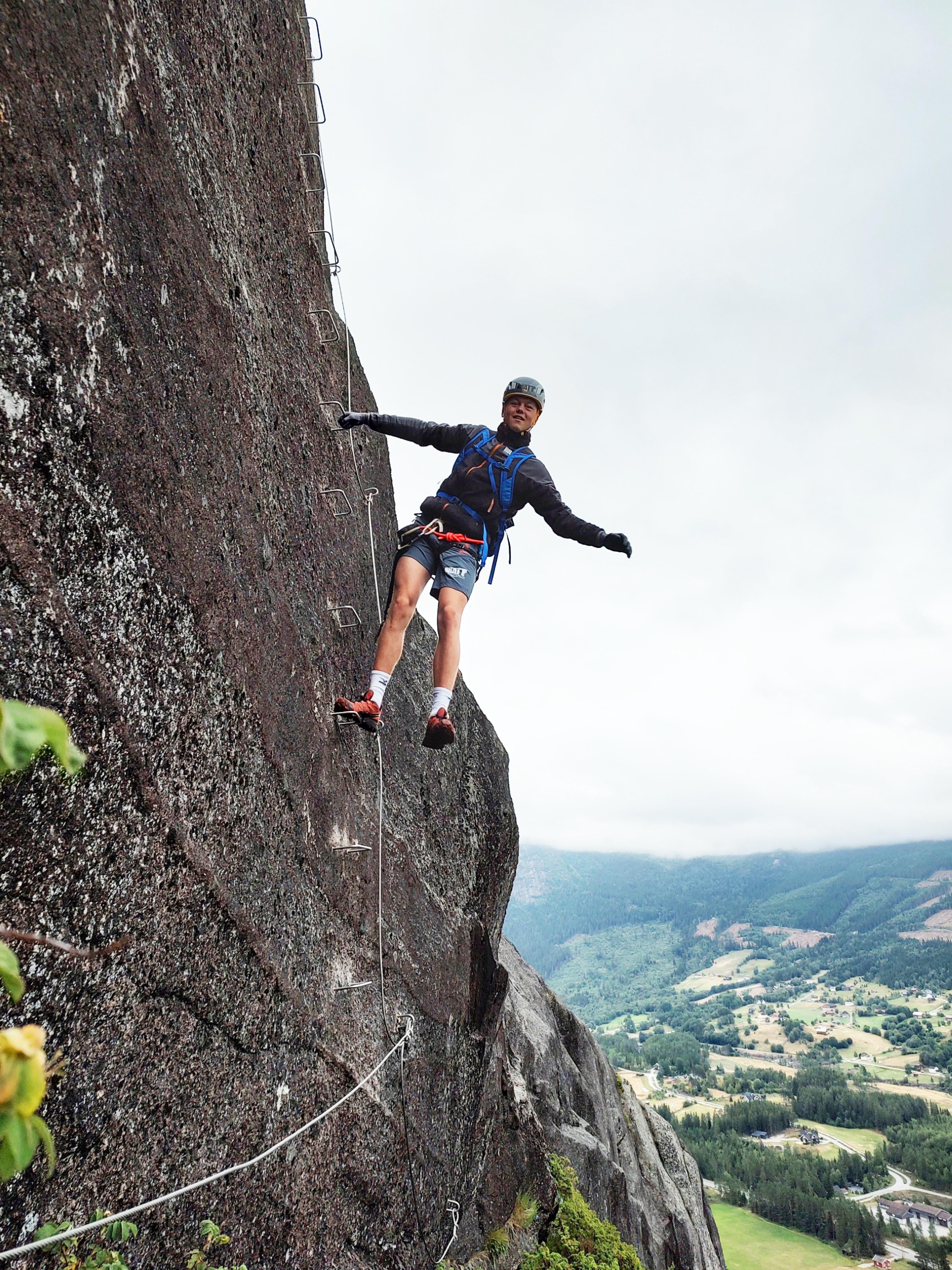 A man climbing in the mountain at the Via Ferrata Nomelandsfjell in Valle