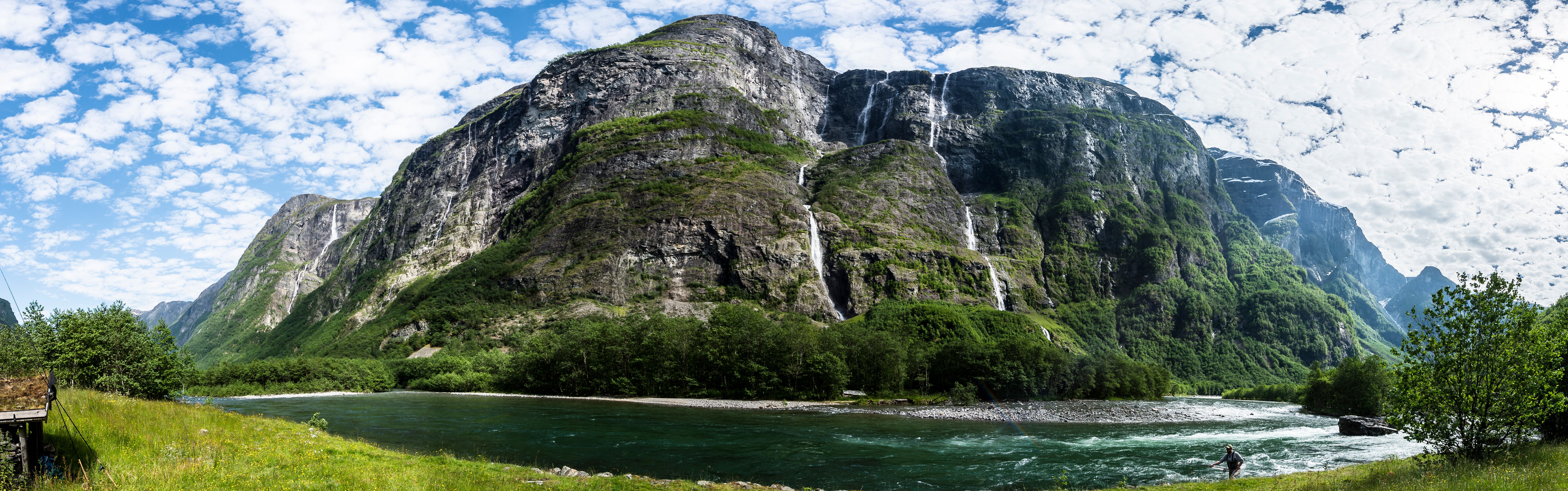 A fisherman fishing for salmon in Nærøydalselva in Fjord Norway