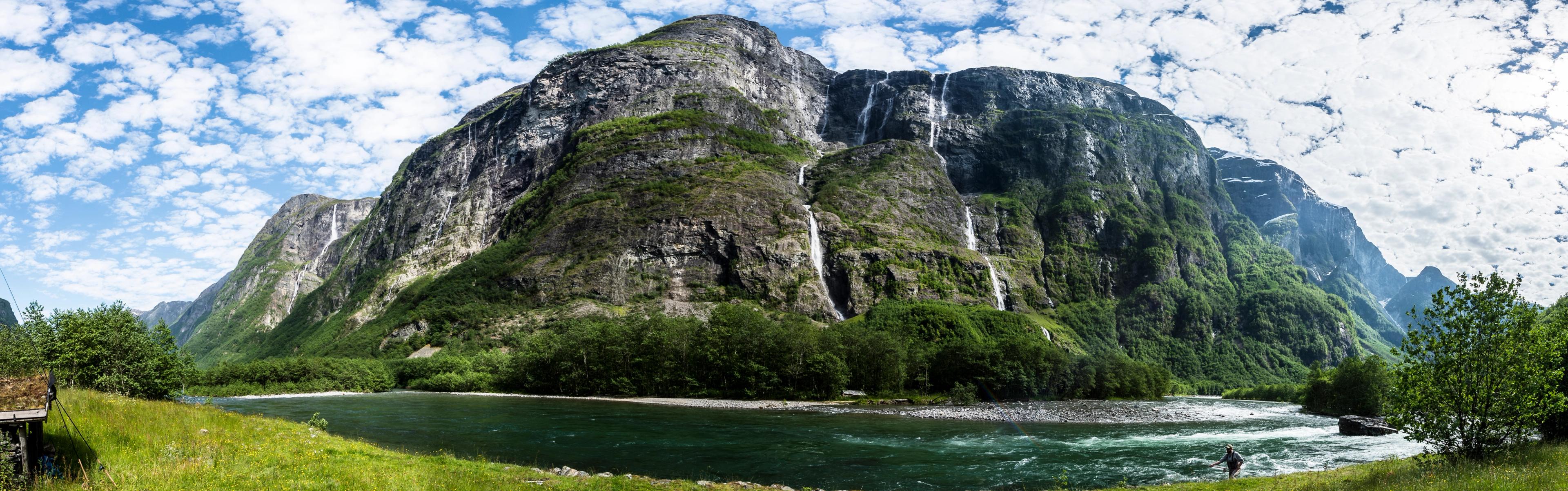 A fisherman fishing for salmon in Nærøydalselva in Fjord Norway