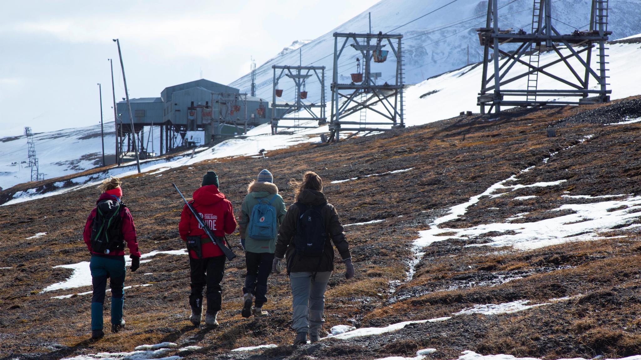 People walking outside Longyearbyen need to go with a guide at Svalbard, Northern Norway
