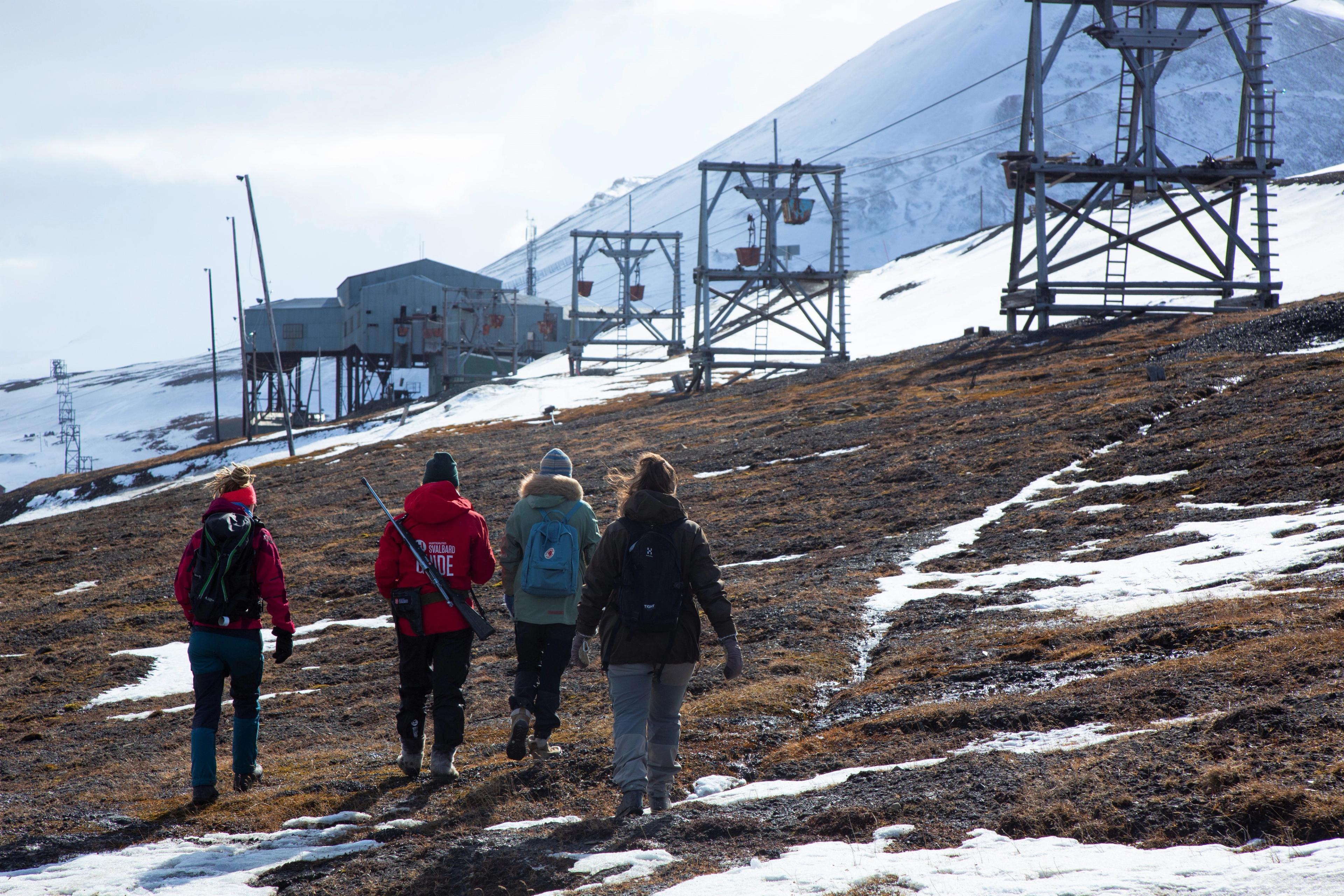 People walking outside Longyearbyen need to go with a guide at Svalbard, Northern Norway