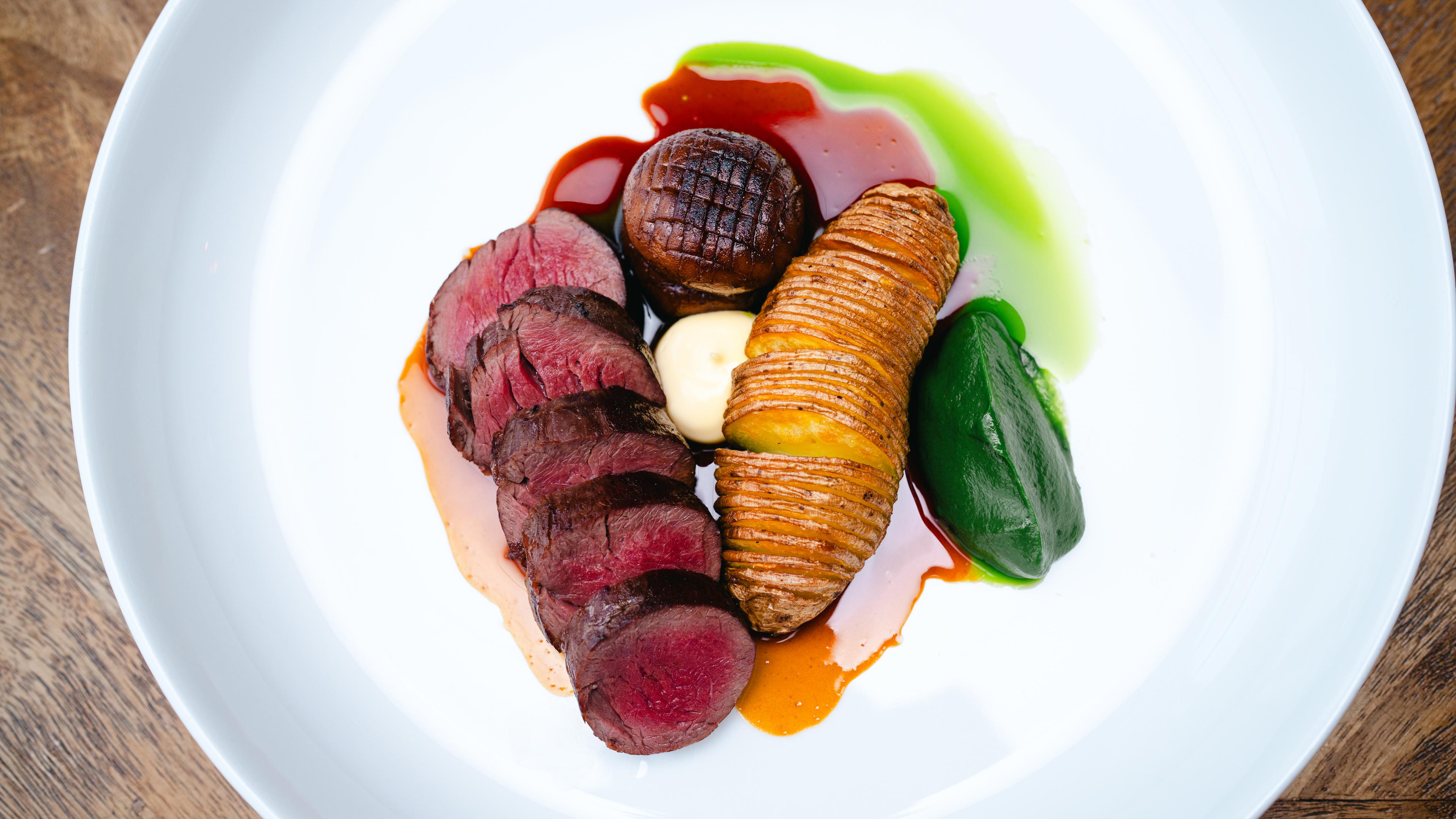 Meat and vegetables on a plate at Skåbu Fjellhotell