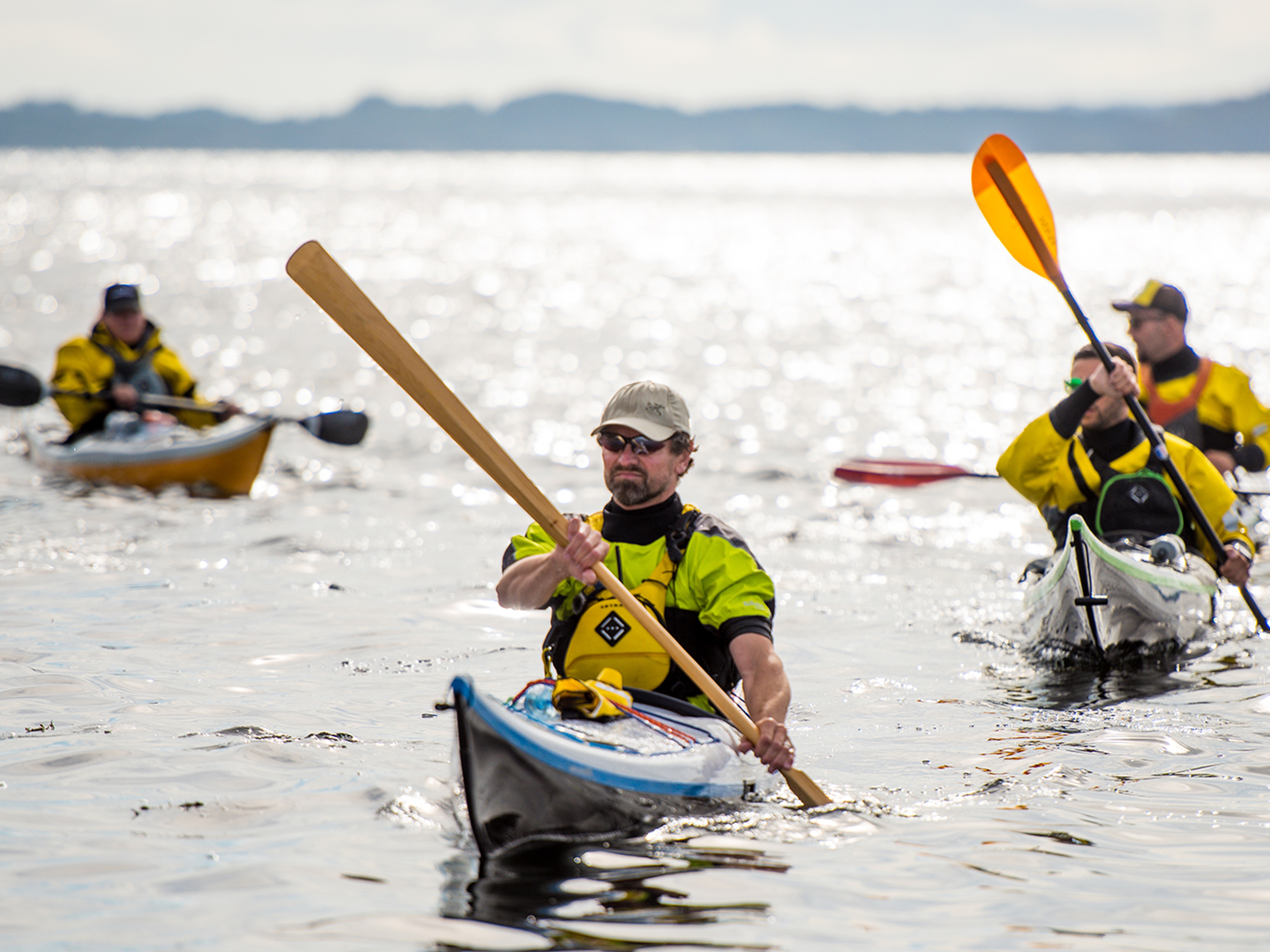 A group of people are kayaking outside of Sotra in Fjord Norway