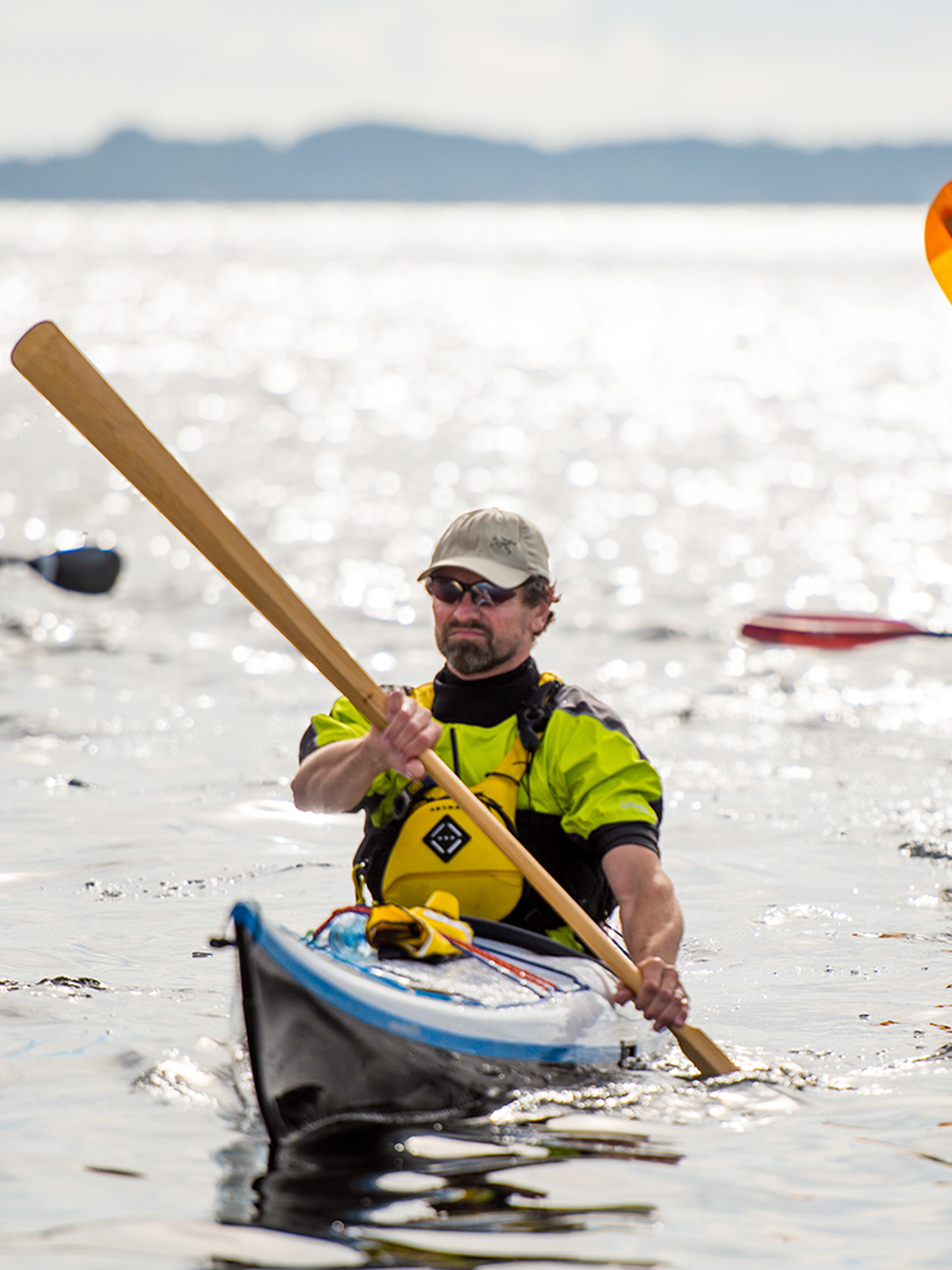 A group of people are kayaking outside of Sotra in Fjord Norway