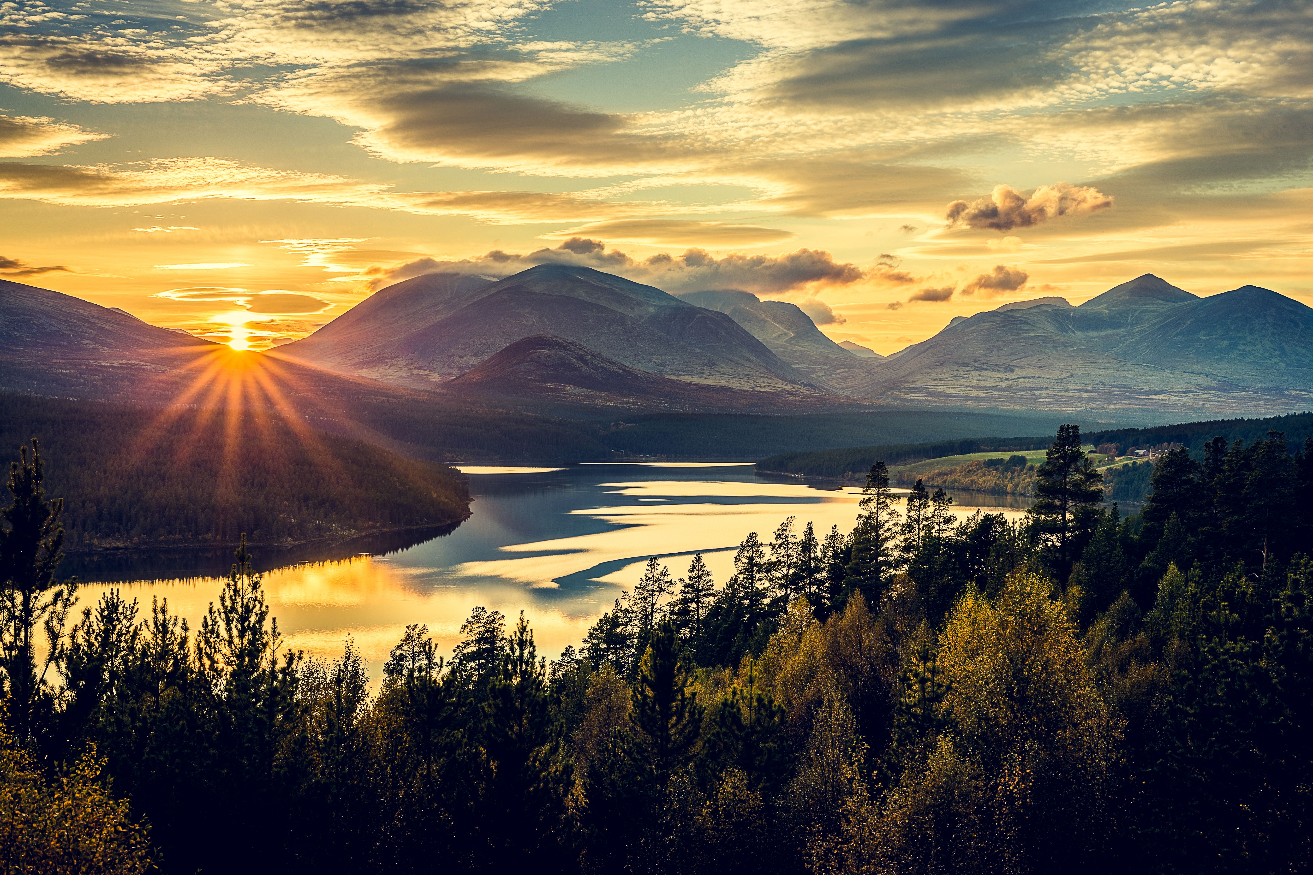 Overview of the mountains, trees and the fjord in Rondane national park, Eastern Norway, at sunset.