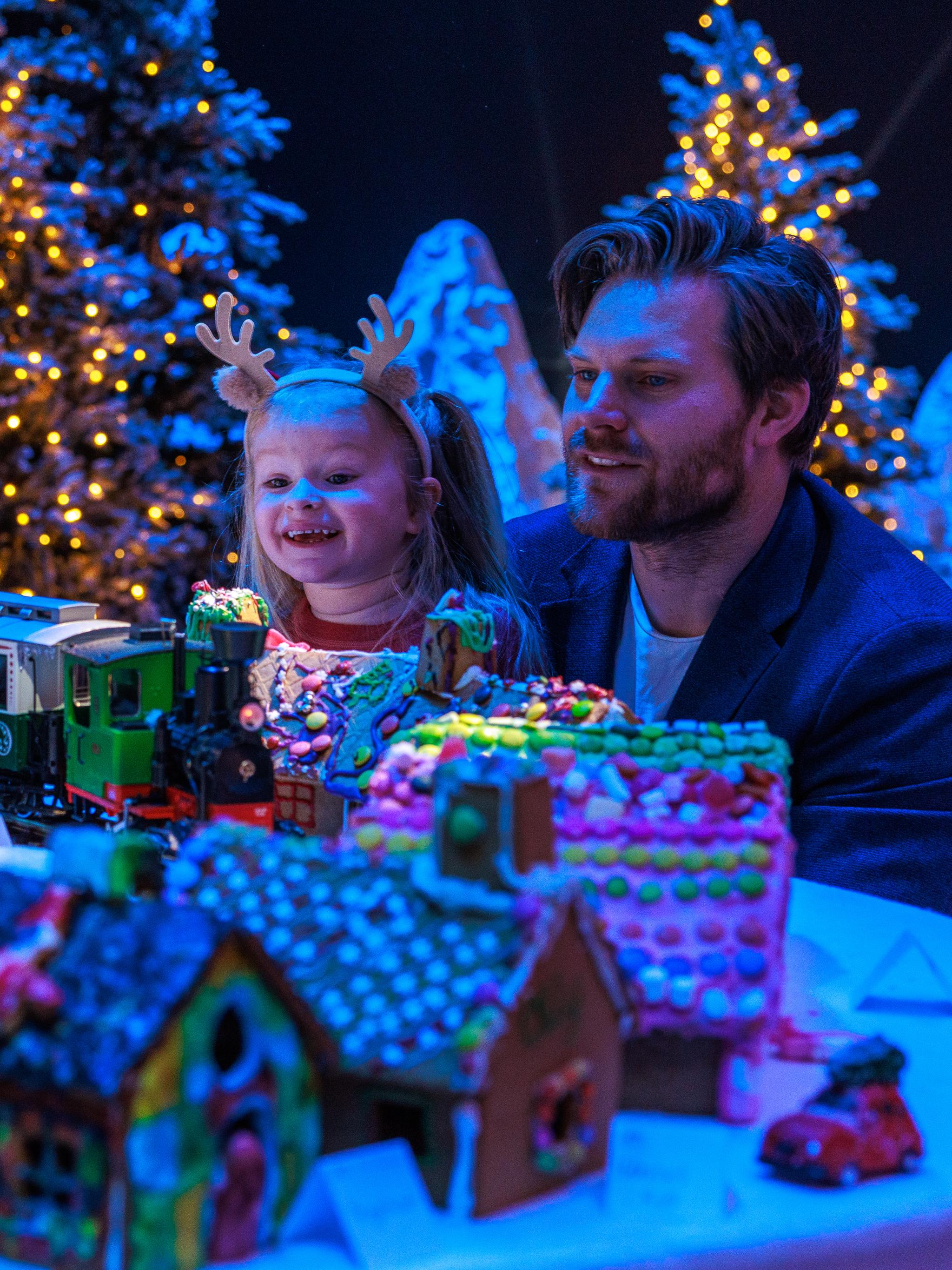 A father and his young daughter looking at the Gingerbread town at the Norwegian Petroleum Museum (Norsk Oljemuseum) in Stavanger