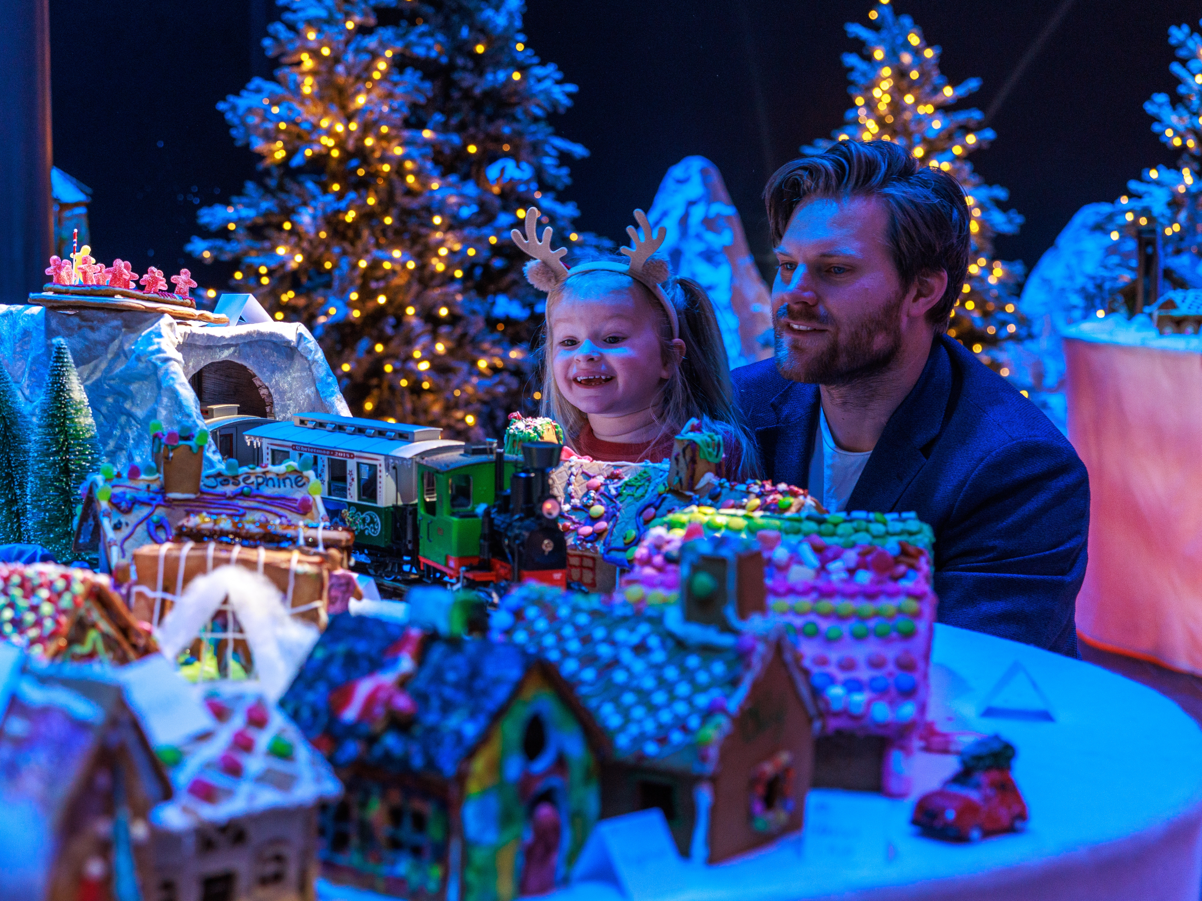 A father and his young daughter looking at the Gingerbread town at the Norwegian Petroleum Museum (Norsk Oljemuseum) in Stavanger