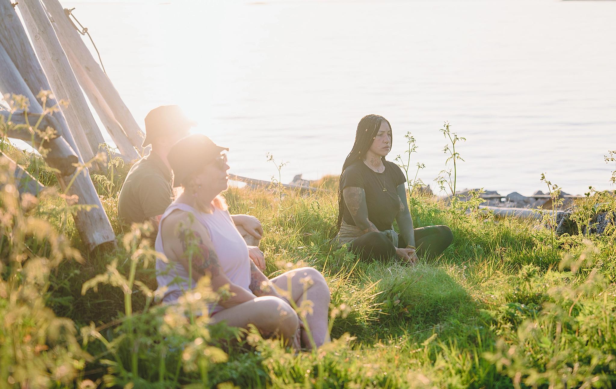 People meditation in the midnight sun in Senja, Troms, Northern Norway.