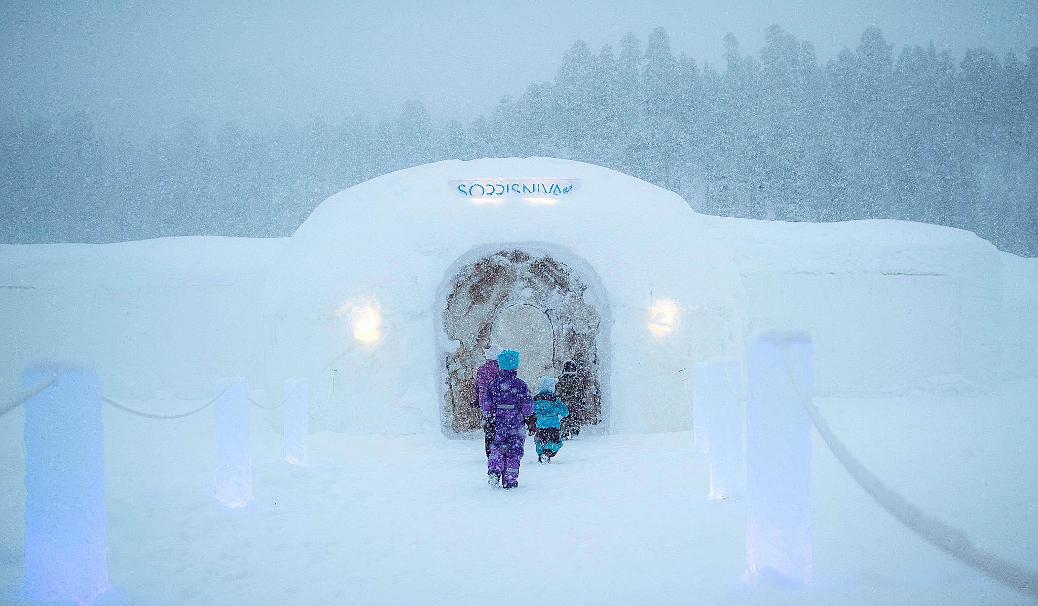 Children entering Sorrisniva Igloo Hotel in Alta, Northern Norway