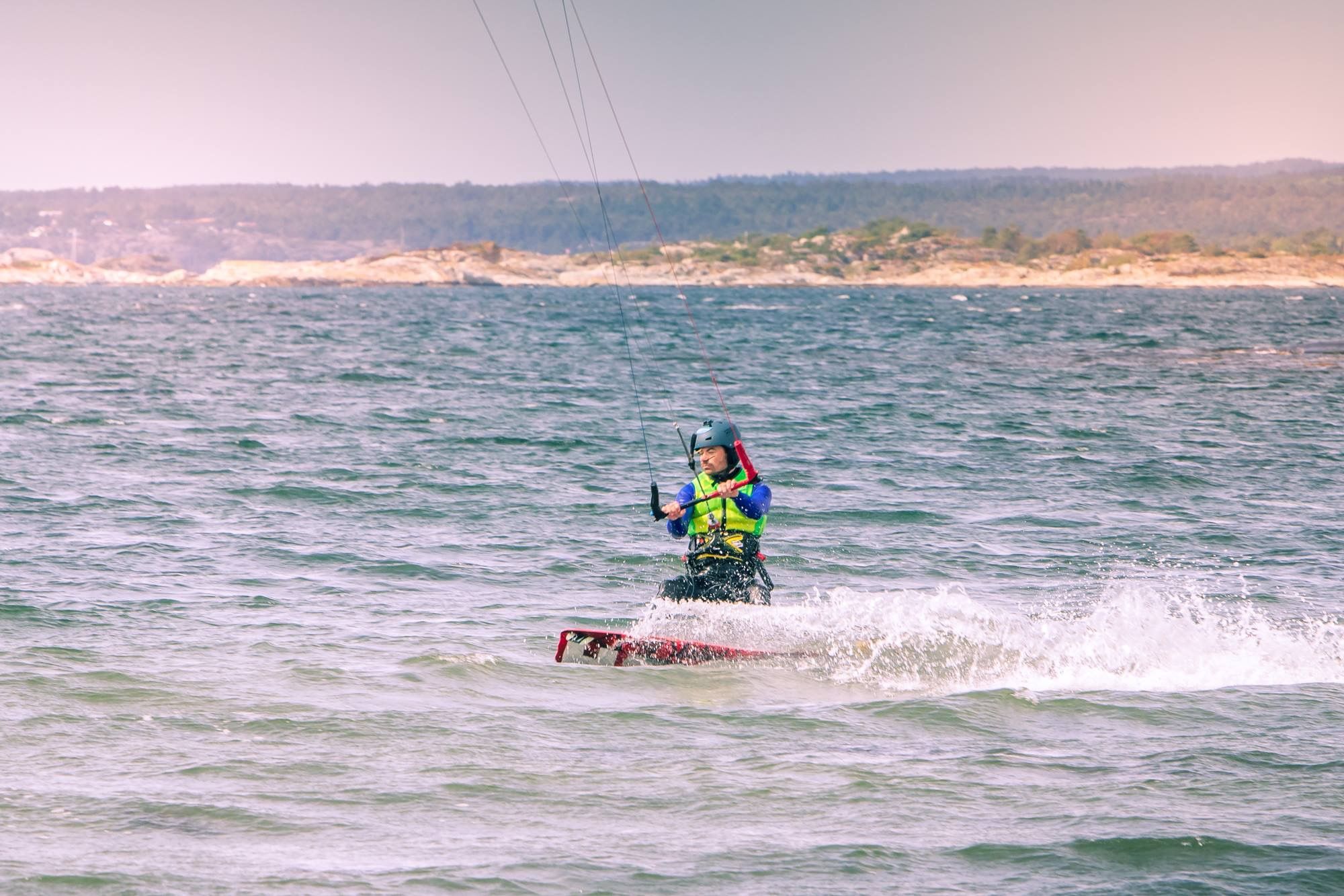 A person kitesurfing near the Jomfruland island in Kragerø, Eastern Norway