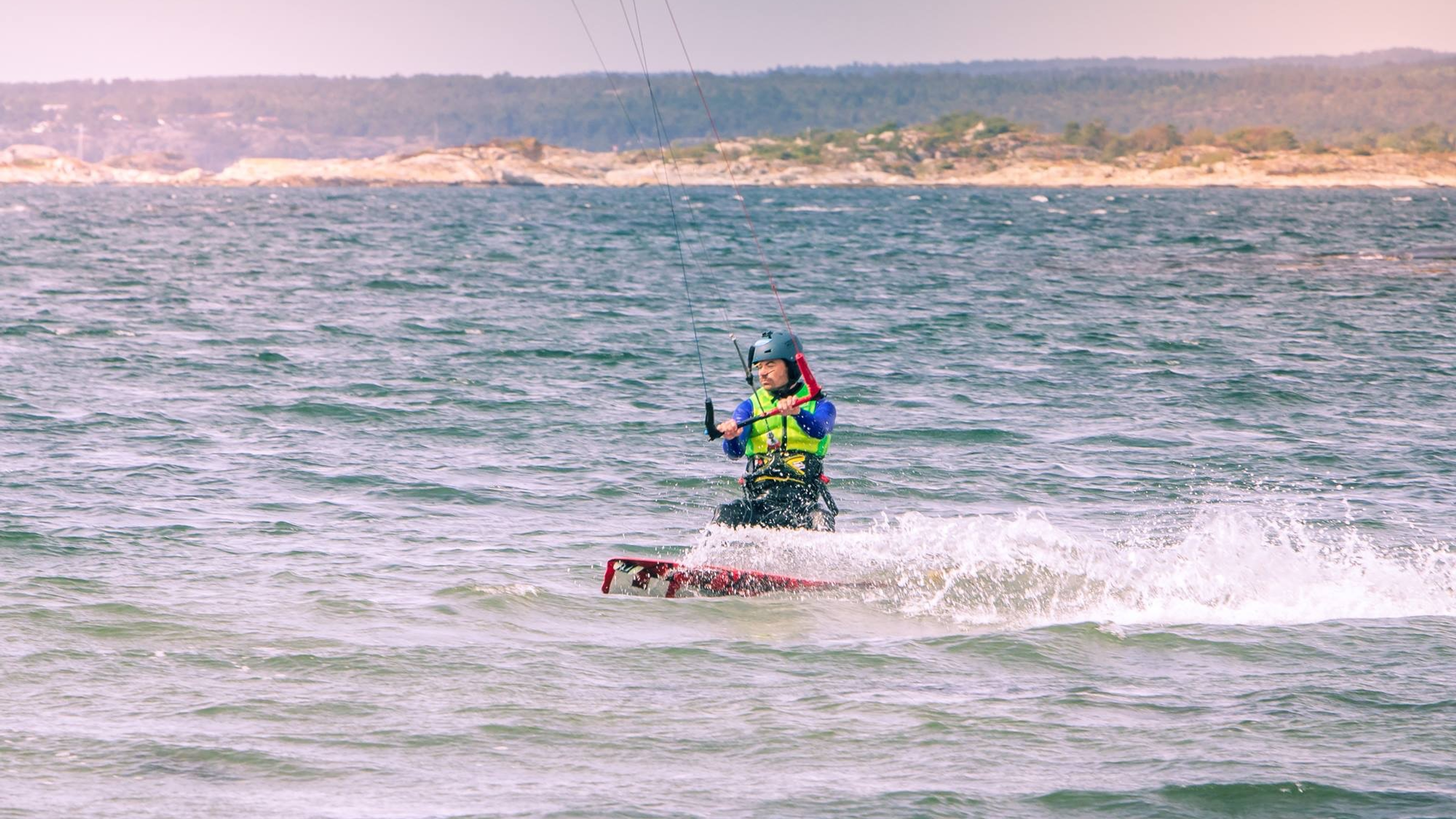 A person kitesurfing near the Jomfruland island in Kragerø, Eastern Norway