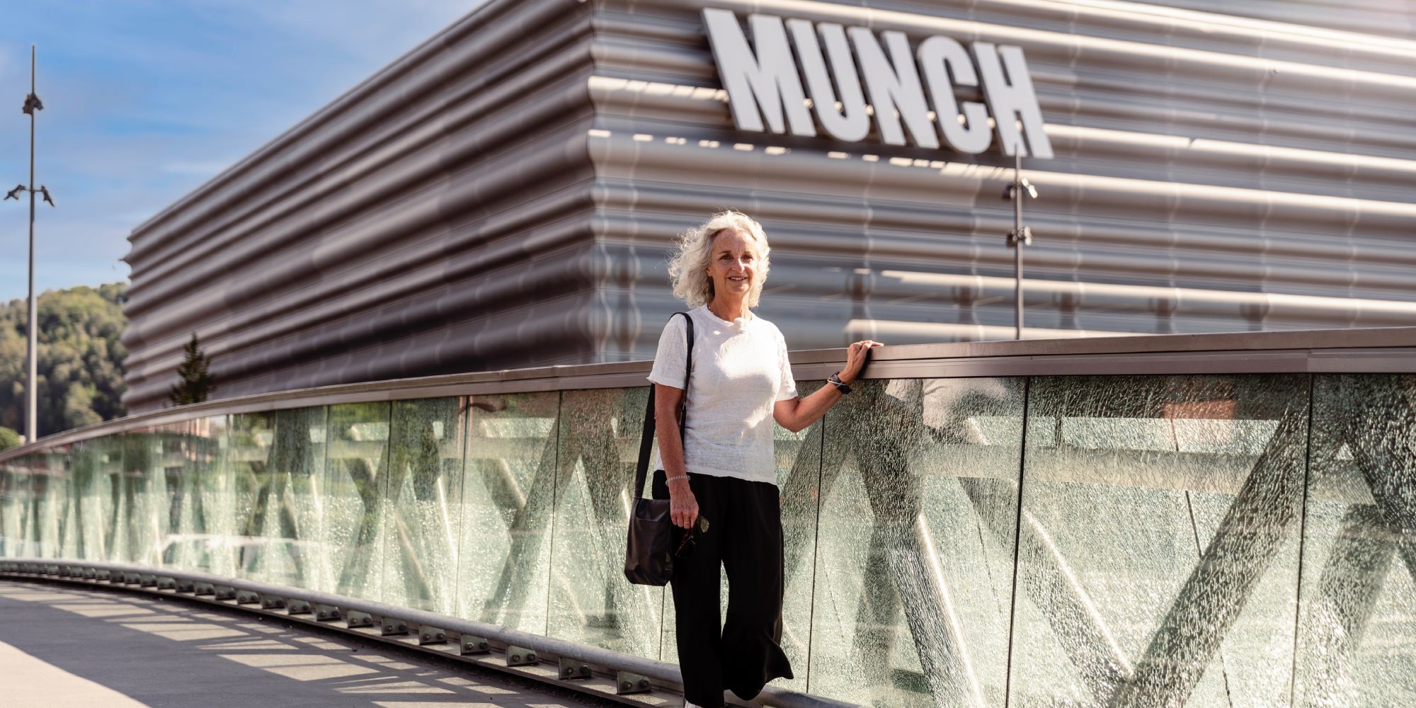 A woman walks past the MUNCH museum