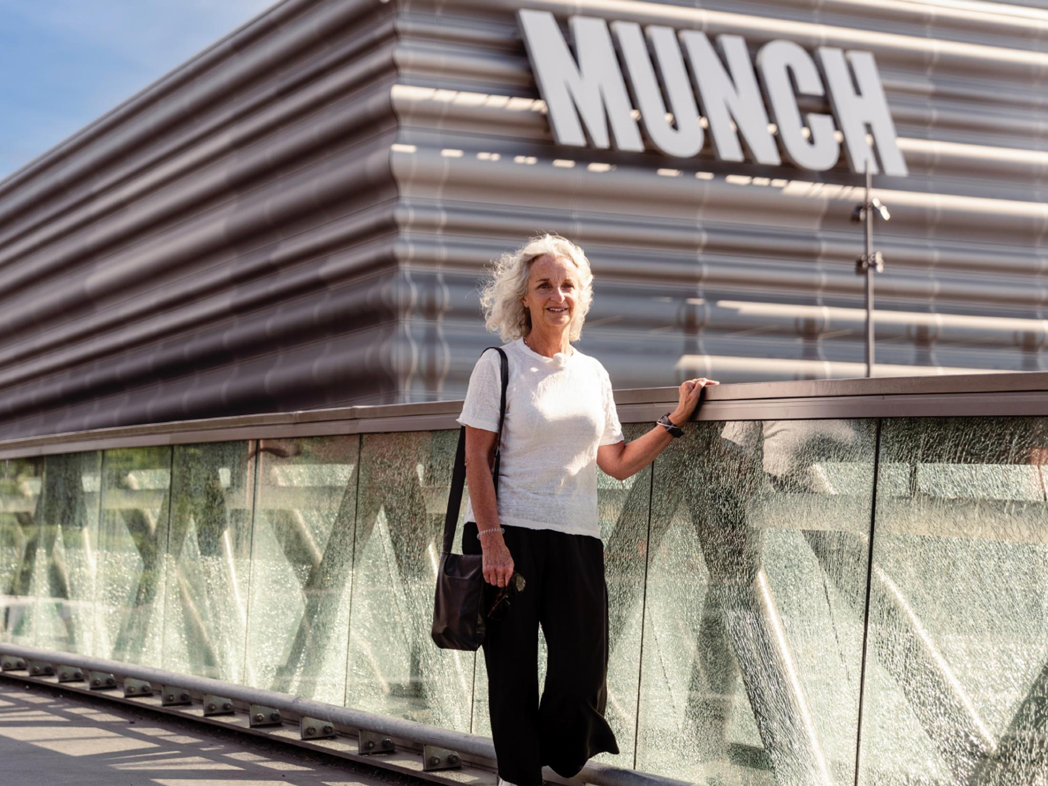 A woman walks past the MUNCH museum