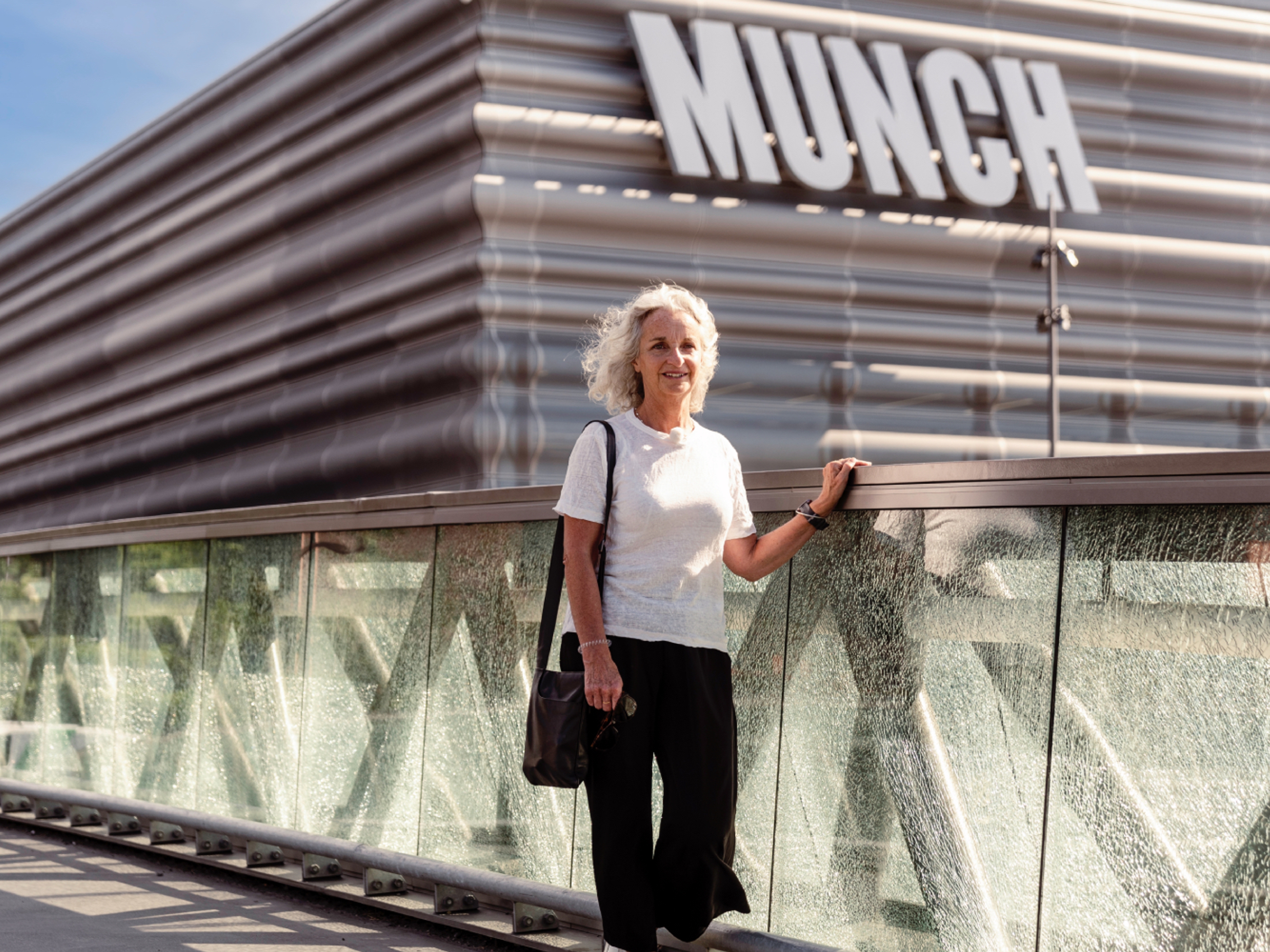 A woman walks past the MUNCH museum