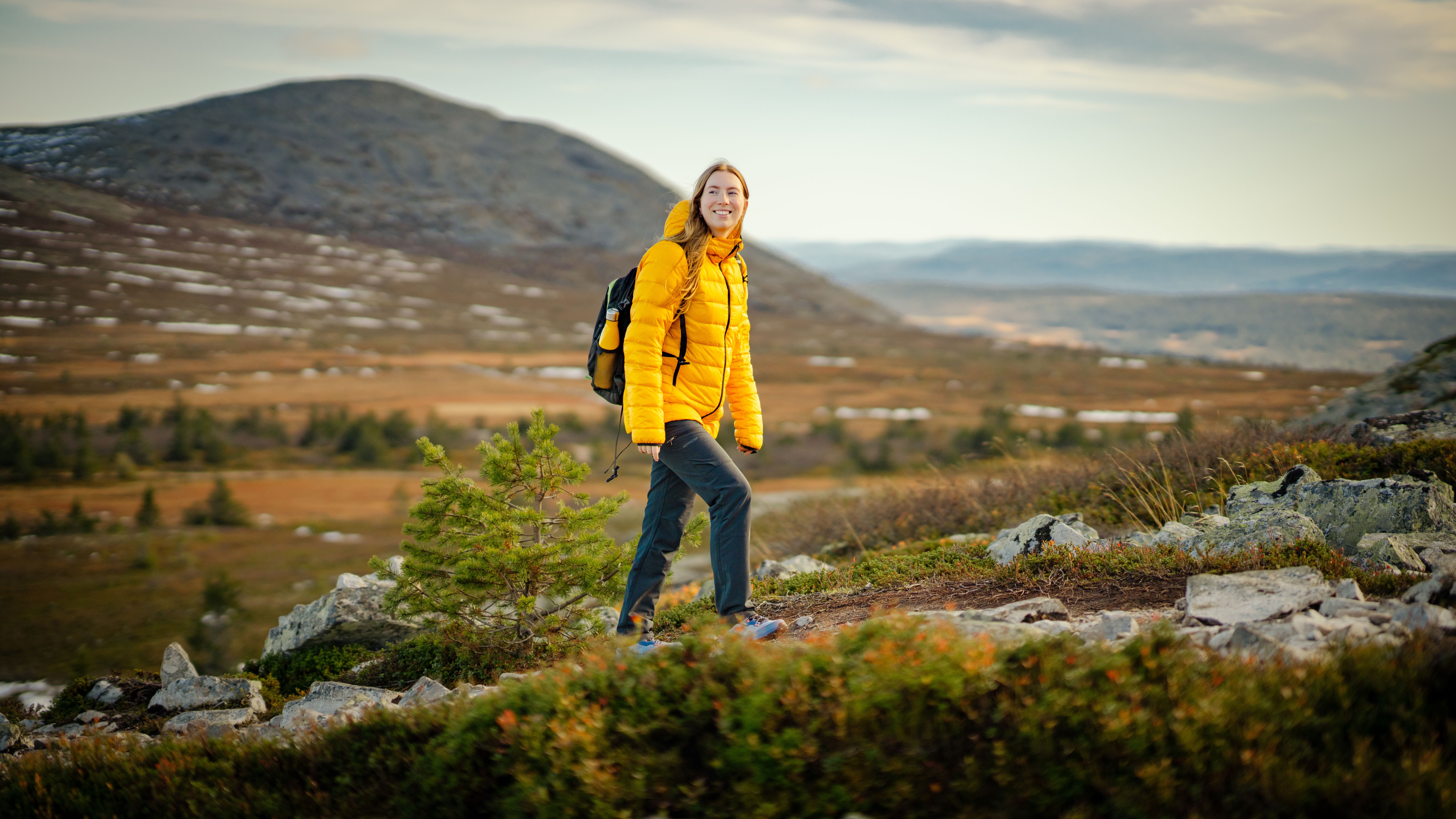 A woman hiking up a mountain in Trysil